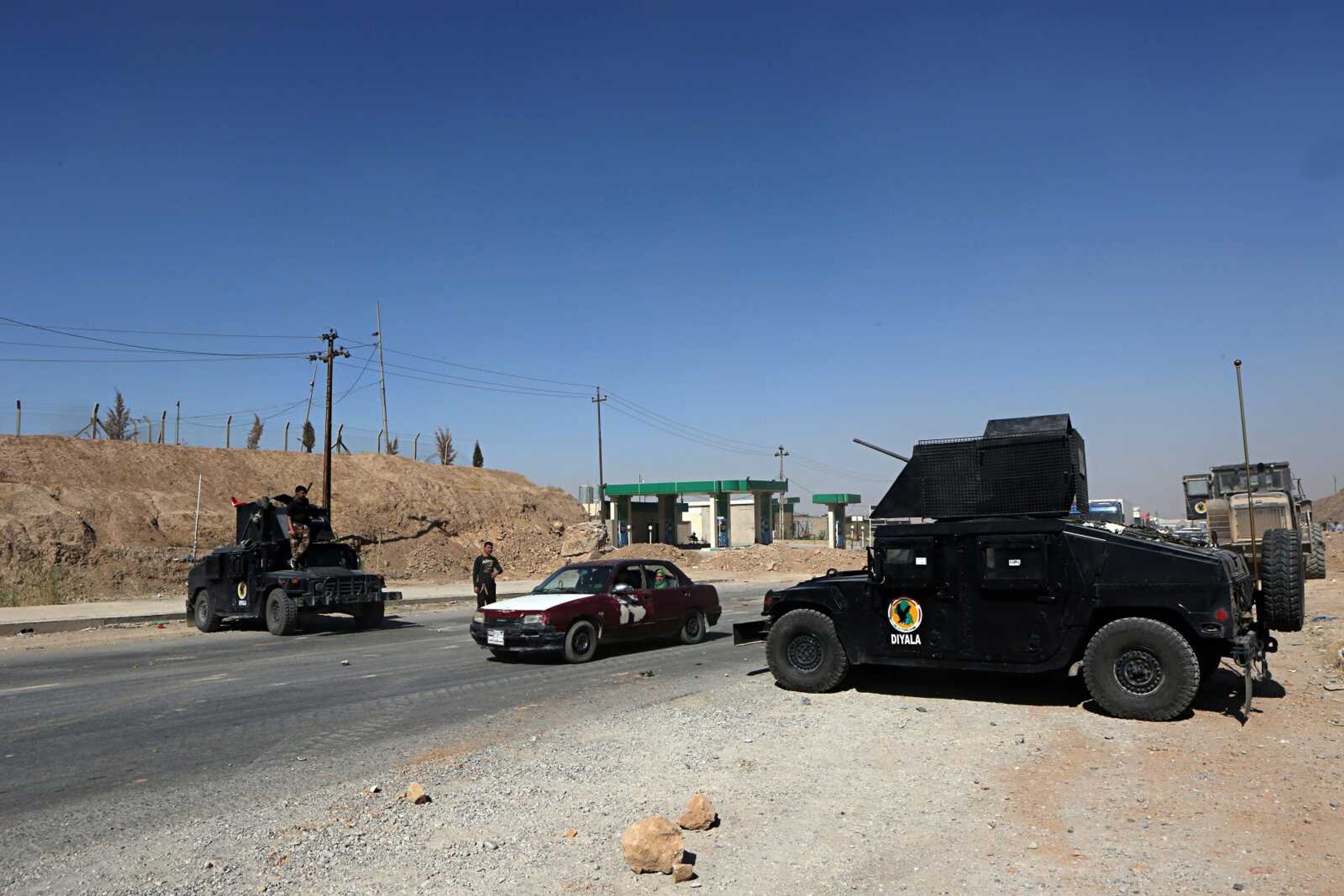 Federal security forces and local police man a checkpoint at the northern entrance to Kirkuk, Iraq. Islamic State insurgent attacks and kidnappings are on the rise in northern Iraq, particularly around the city of Kirkuk were political tensions have further fractured security forces there.