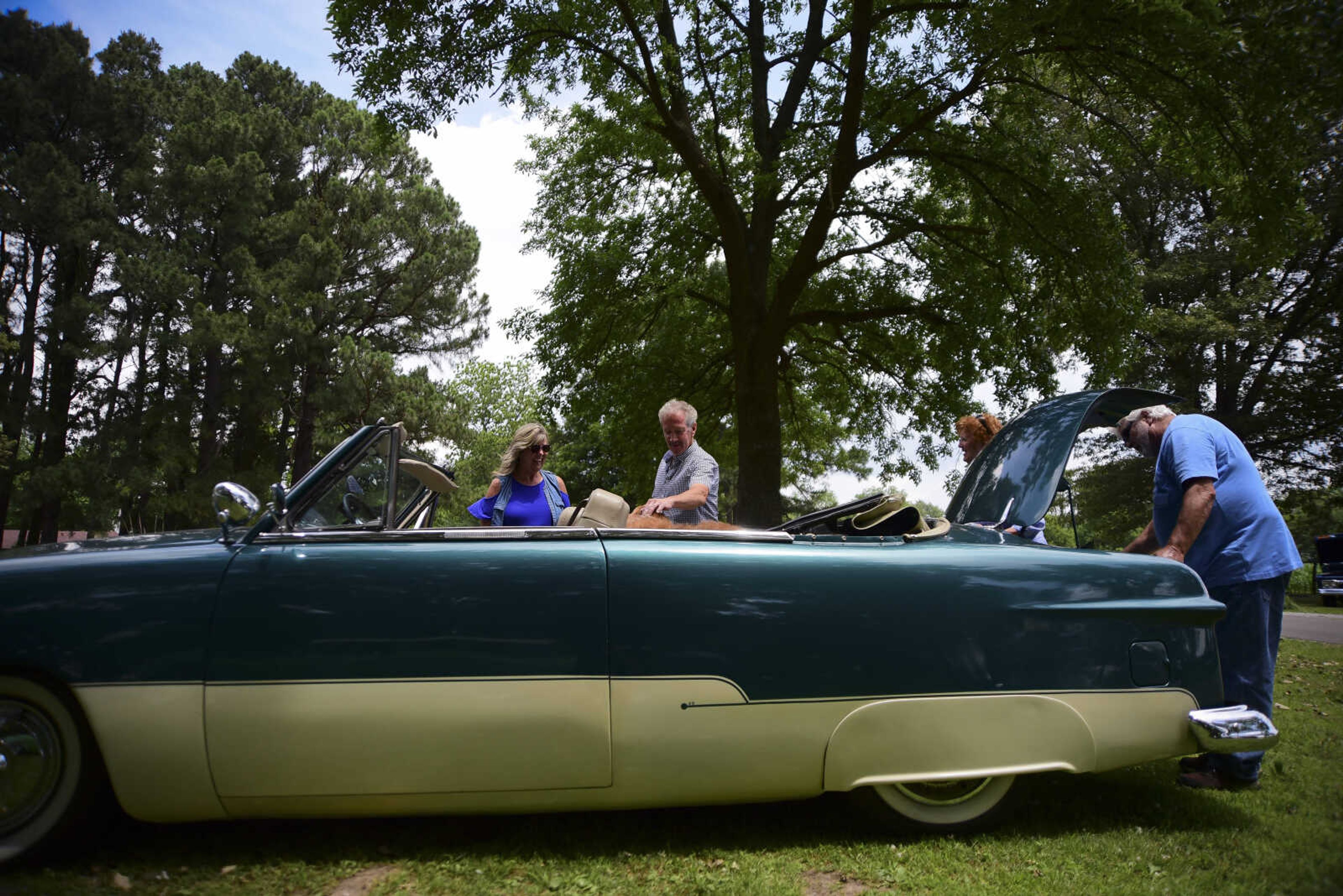 People look at vehicles during the 22nd annual Oran Car Show at George Tilles Jr. Memorial Park Saturday, June 3, 2017 in Oran.