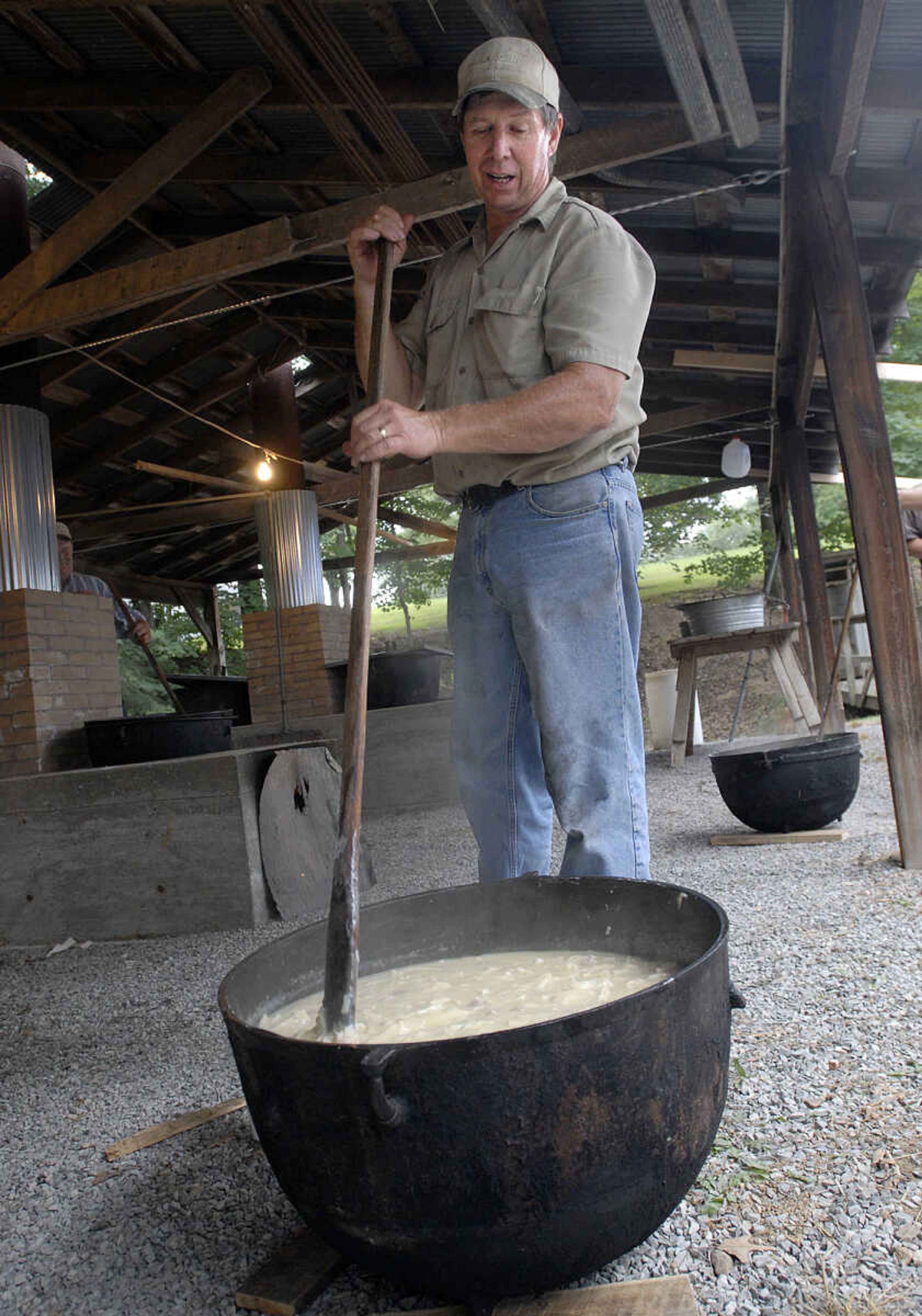 Wayne Thiele stirs one of the 12 kettles of chicken and dumplings for the Leopold Picnic.