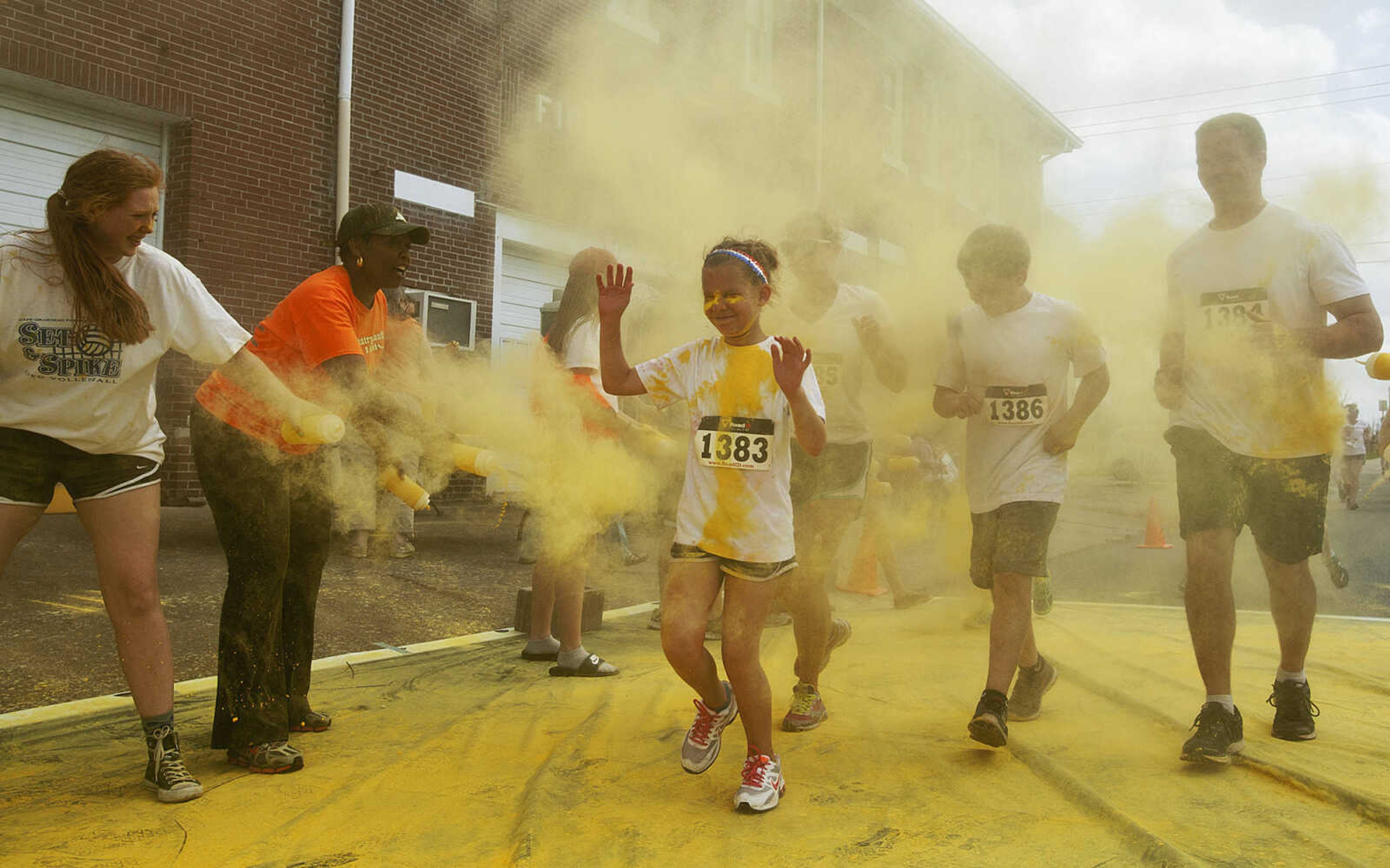 ADAM VOGLER ~ avogler@semissourian.com
Participants in the Color Me Cape 5k run through the yellow color station north of the intersection of Independence Street and Frederick Street Saturday, April 12, in Cape Girardeau.