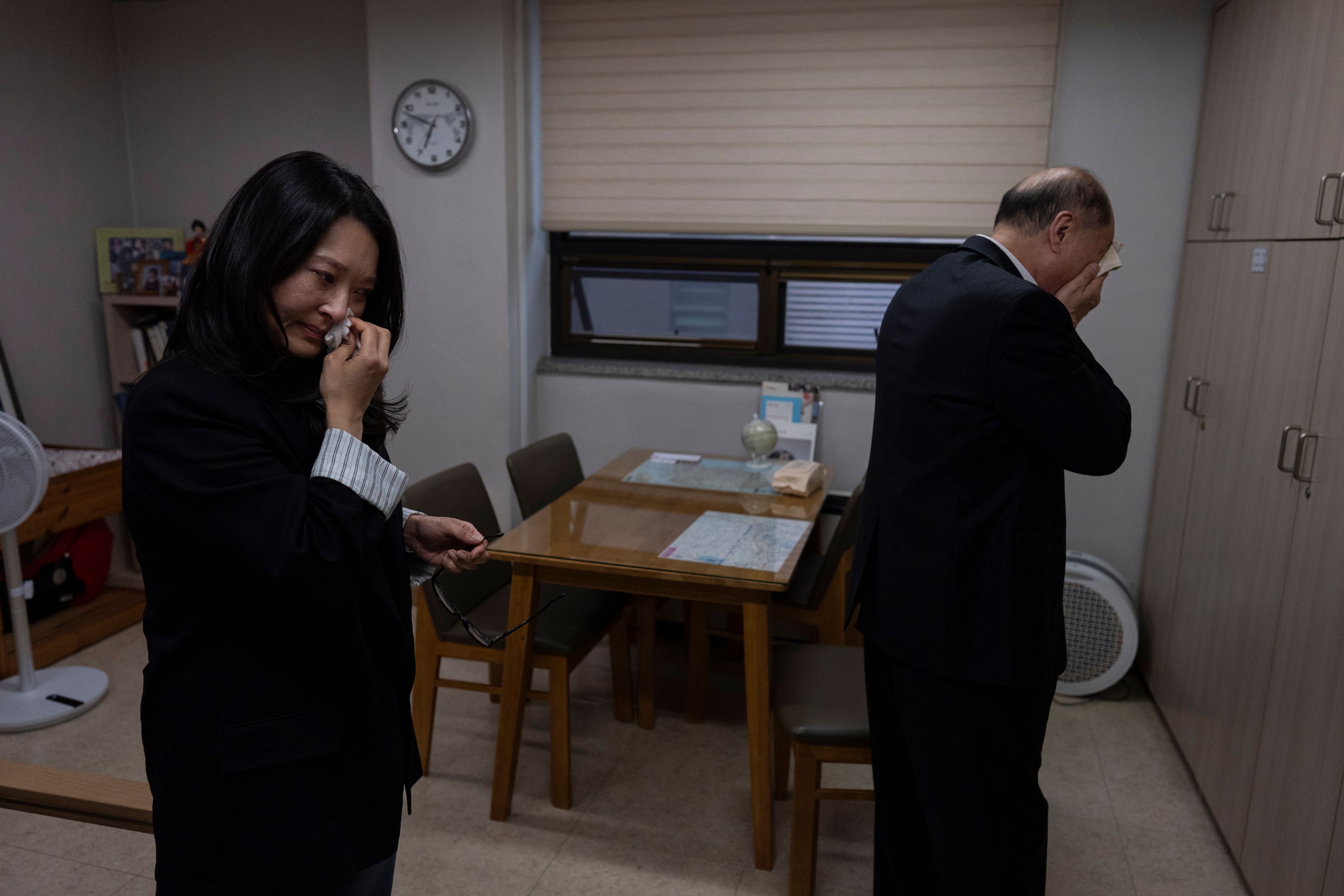 Adoptee Nicole Motta, left, and her birth father, Jang Dae-chang, wipe tears after an emotional reunion at the Eastern Social Welfare Society in Seoul, Friday, May 31, 2024. The moment they hugged, Motta, adopted to the United States in 1985, didn't need DNA test results, she knew she'd come from this man. "I am a sinner for not finding you," he said. "I think I have your nose," Motta said softly. They both sobbed. (AP Photo/Jae C. Hong)