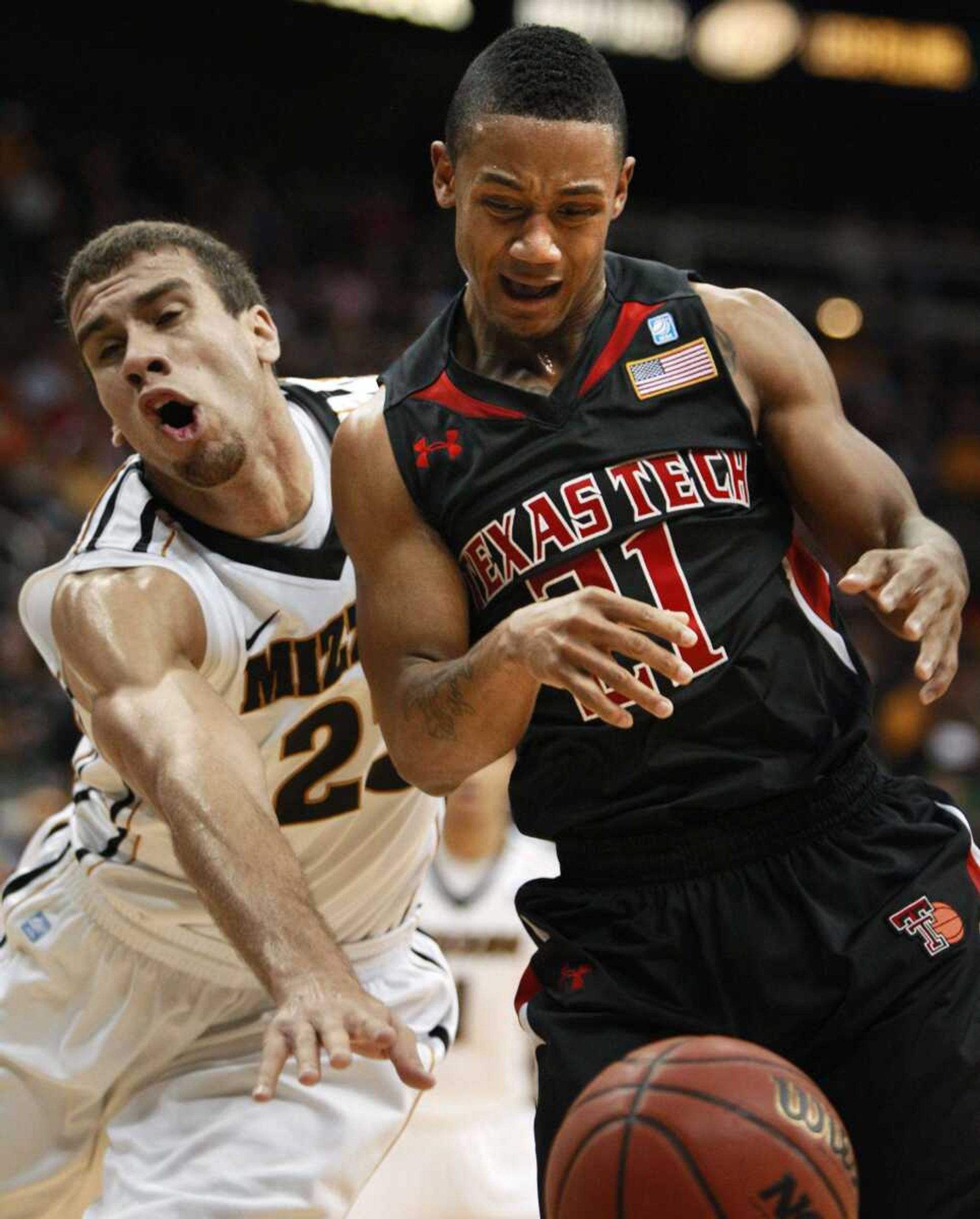 Missouri forward Justin Safford (23) and Texas Tech guard John Roberson (21) watch the ball during the first half of an NCAA college basketball game in the first round of the Big 12 men's tournament in Kansas City, Mo., Wednesday, March 9, 2011. (AP Photo/Orlin Wagner)