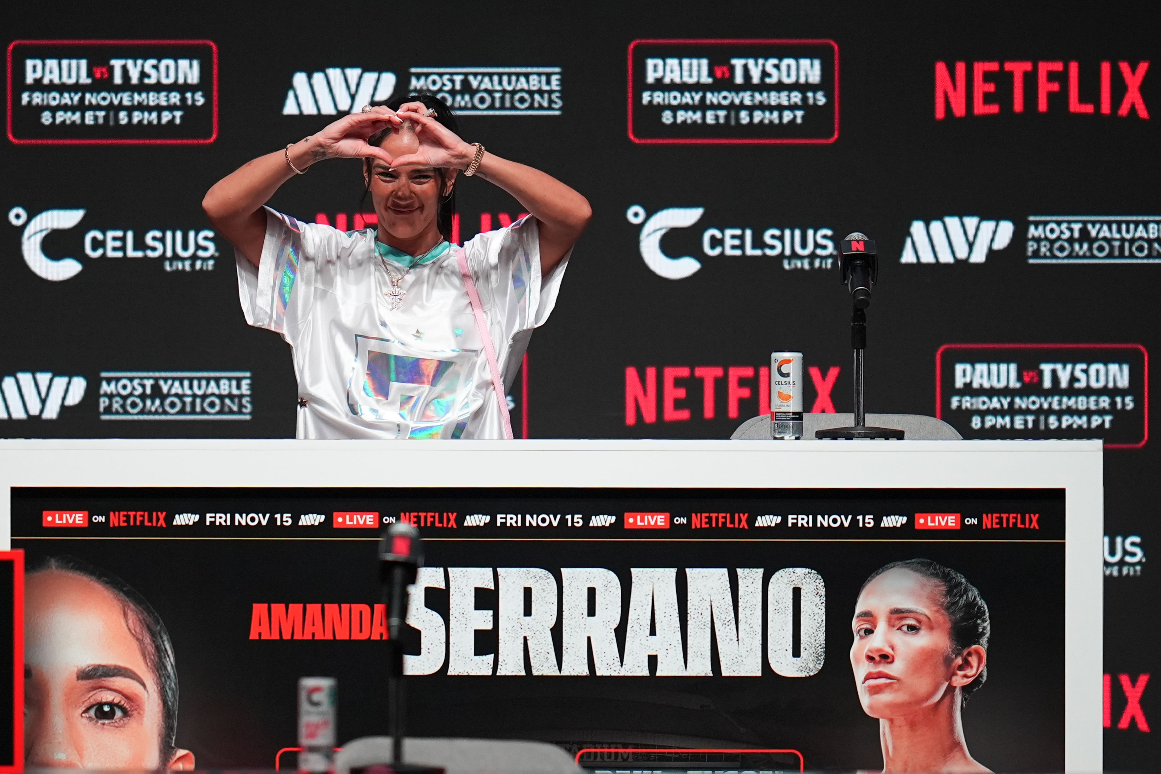 Amanda Serrano gestures during a news conference ahead of her undisputed super lightweight world title bout against Katie Taylor, the co-main event in the Mike Tyson vs. Jake Paul fight night, Wednesday, Nov. 13, 2024, in Irving, Texas. (AP Photo/Julio Cortez)