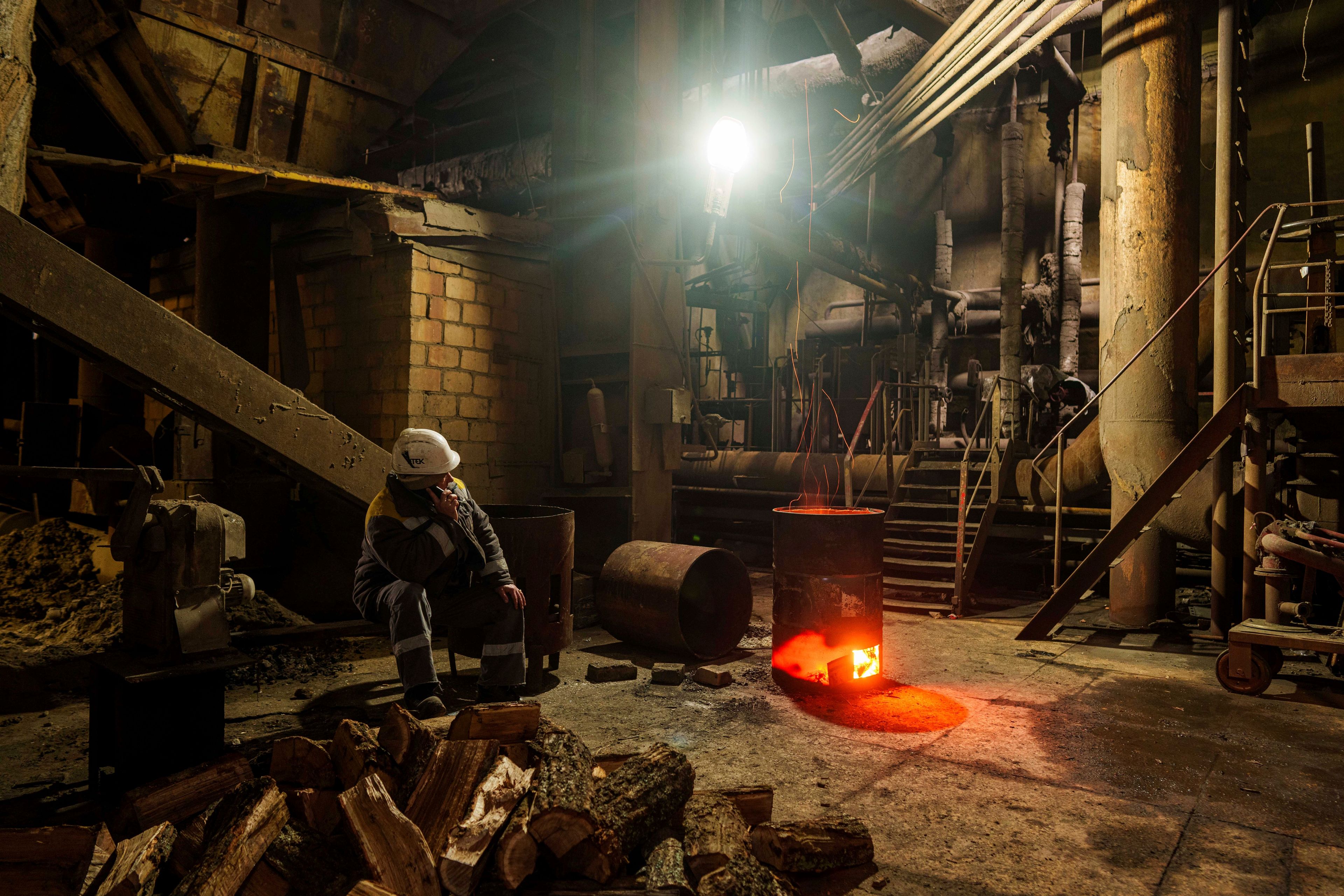 A worker speaks by mobile phone at DTEK's power plant after a recent Russian missile attack in Ukraine, Nov. 28, 2024. (AP Photo/Evgeniy Maloletka)