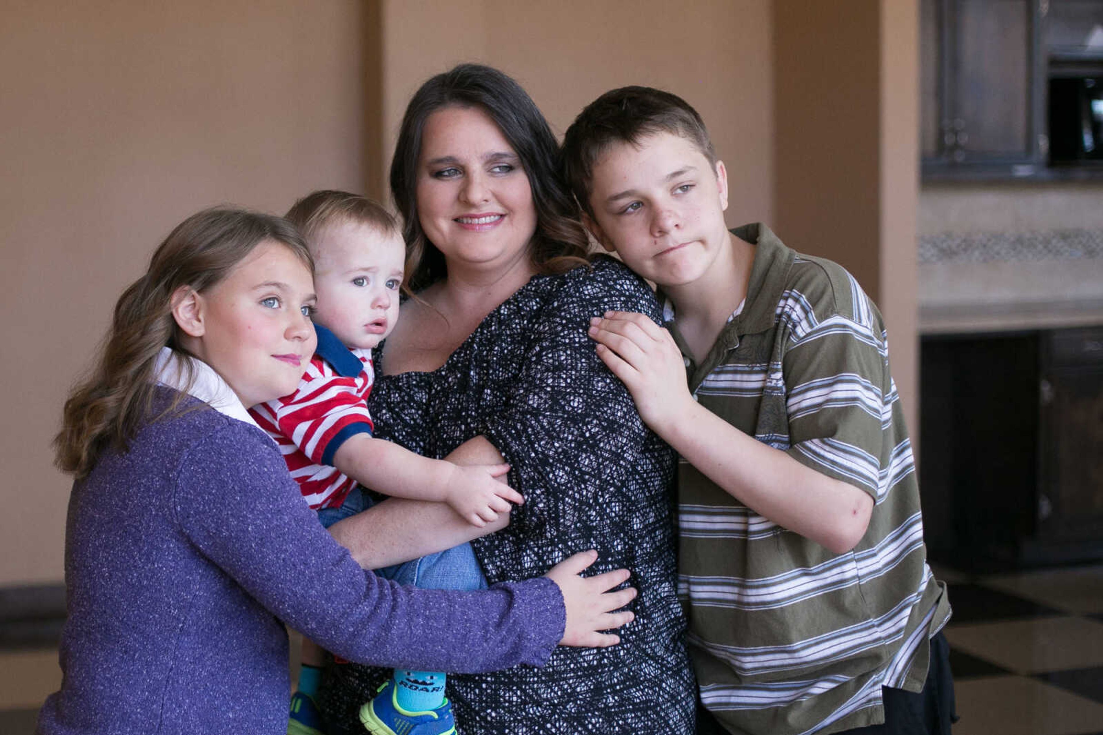 GLENN LANDBERG ~ glandberg@semissourian.com

Kristina Meyer and her family, Madyson Palmer, Kellan Palmer and Patrick Meyer  pose for volunteer photographer Richard Lynn during the Help-Portrait event at the House of Hope Saturday, Dec. 5, 2015 in Cape Girardeau.