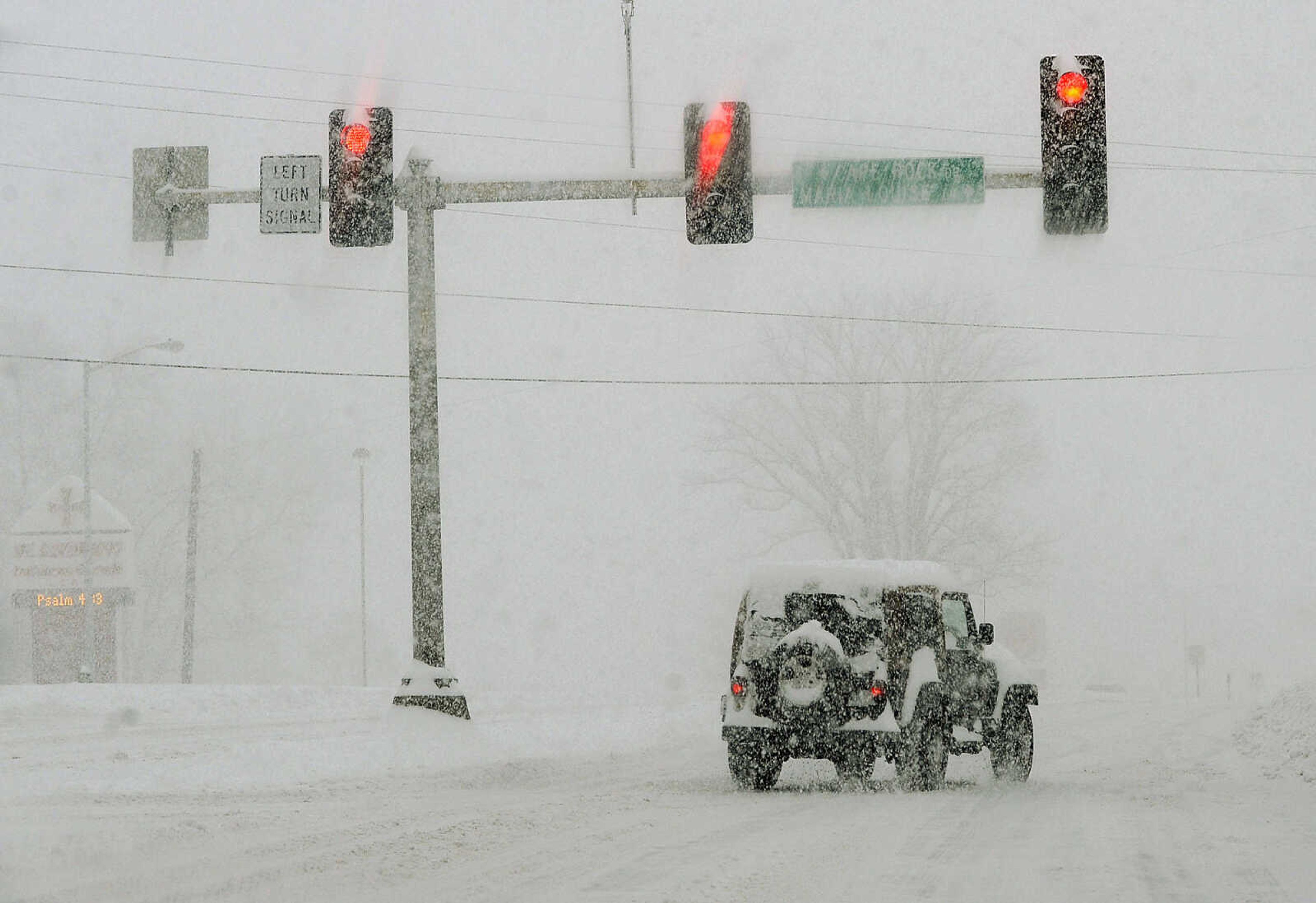 FRED LYNCH ~ flynch@semissourian.com
A motorist turns onto North Kinghighway from North Cape Rock Drive as snow falls Monday morning, Feb. 16, 2015 in Cape Girardeau.