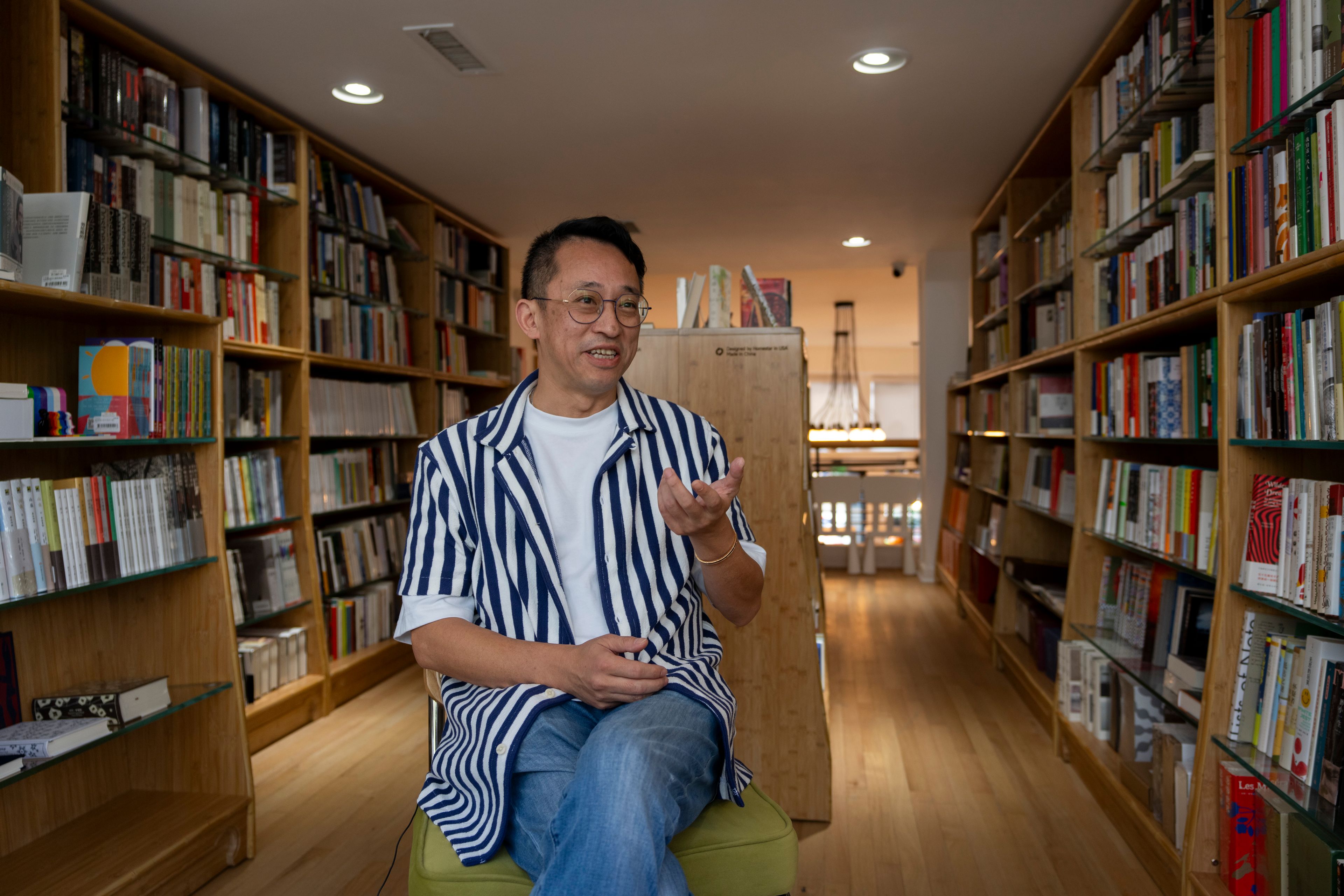 Yu Miao, owner of JF Books, speaks to The Associated Press in his bookstore in Washington, Thursday, Oct. 3, 2024. (AP Photo/Ben Curtis)