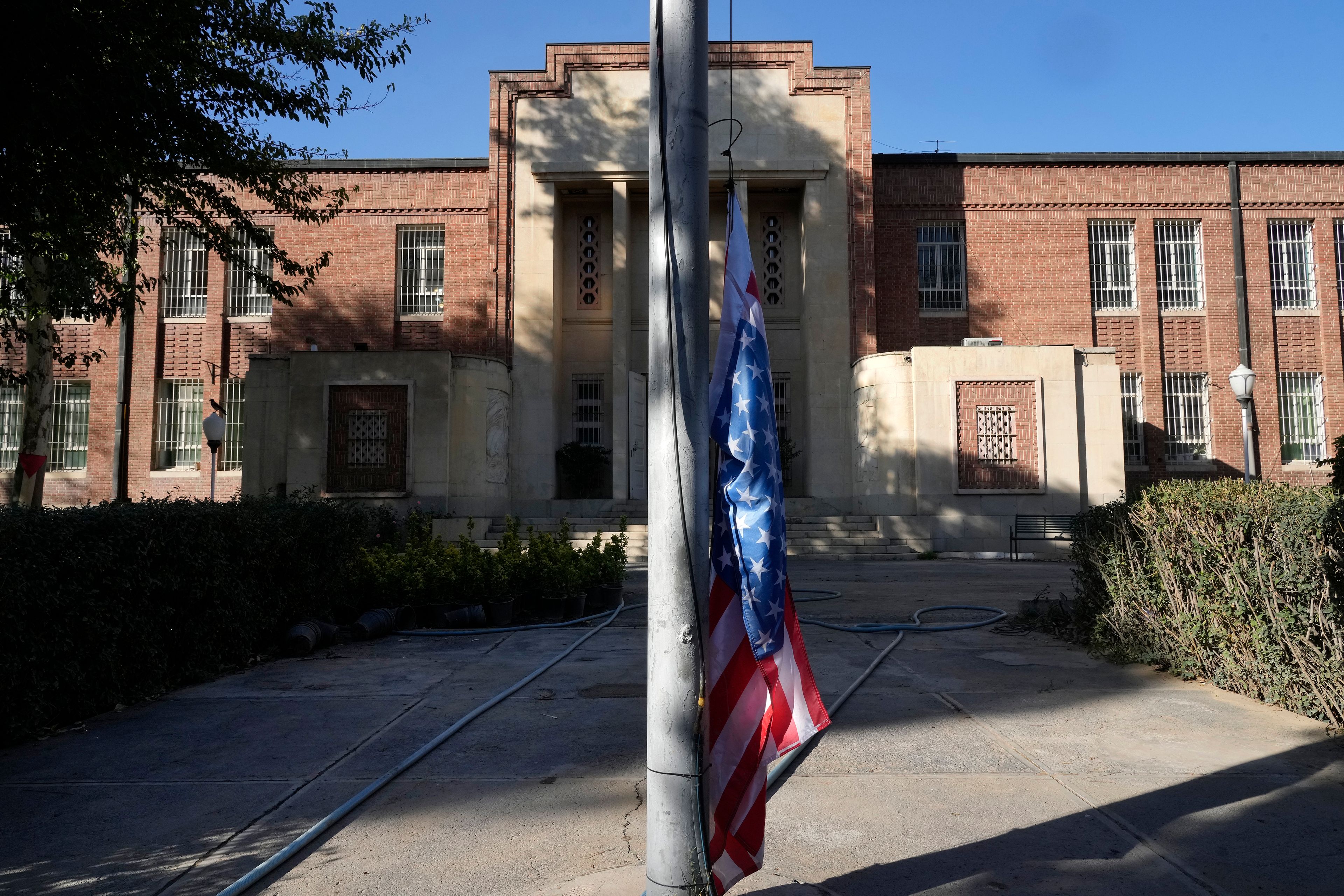 A U.S. flag is placed under a flagpole at the former U.S. Embassy, which has been turned into an anti-American museum, in Tehran, Iran, Tuesday, Oct. 22, 2024. (AP Photo/Vahid Salemi)