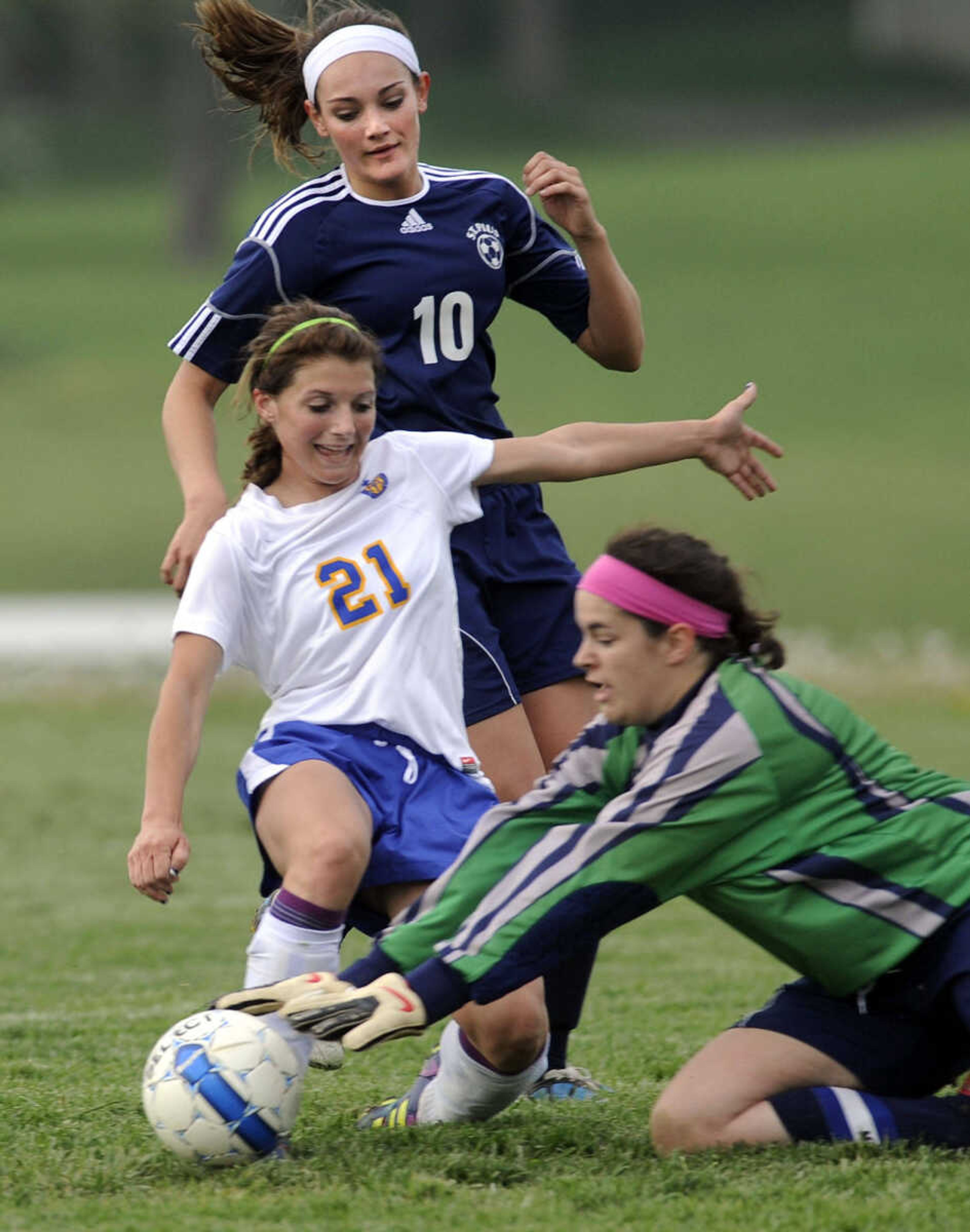 St. Pius goalkeeper Madeline Smith gets to the ball before St. Vincent's Holly Blandford with Alex Ottoline behind her during the first half Wednesday, April 4, 2012 in Perryville, Mo. (Fred Lynch)