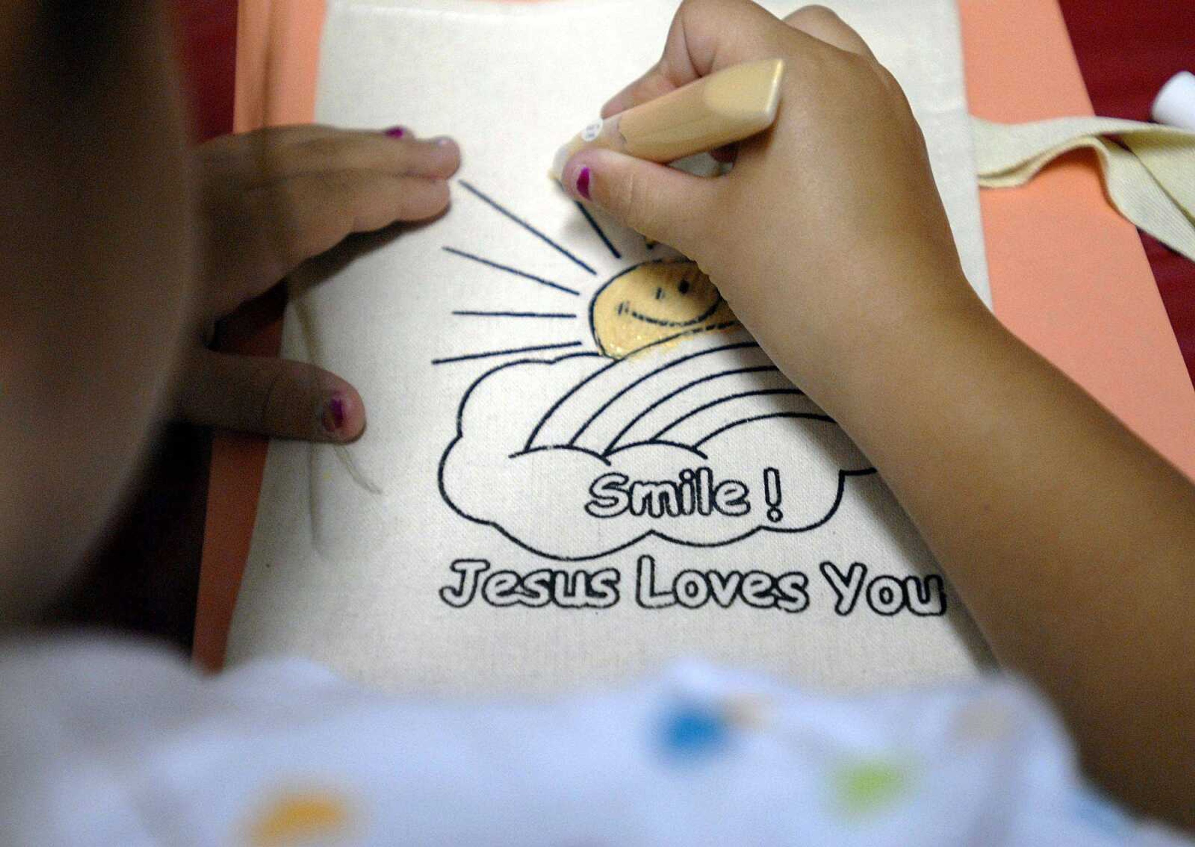 A class for 7-to-8-year-olds paints hand bags during craft time at a vacation Bible school called "Going to the Promised Land Thursday at Lighthouse Baptist Church in Cape Girardeau. (Elizabeth Dodd)