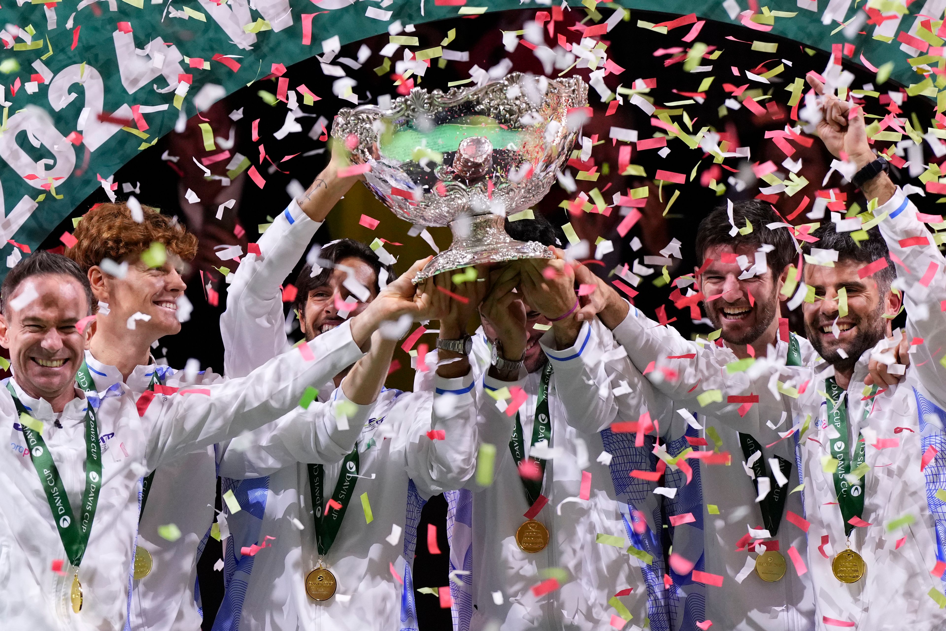 Italian tennis team members hold the Davis Cup trophy after the final between Netherlands and Italy at the Martin Carpena Sports Hall in Malaga, southern Spain, as Italy wins its second consecutive Davis Cup title, Sunday, Nov. 24, 2024. (AP Photo/Manu Fernandez)