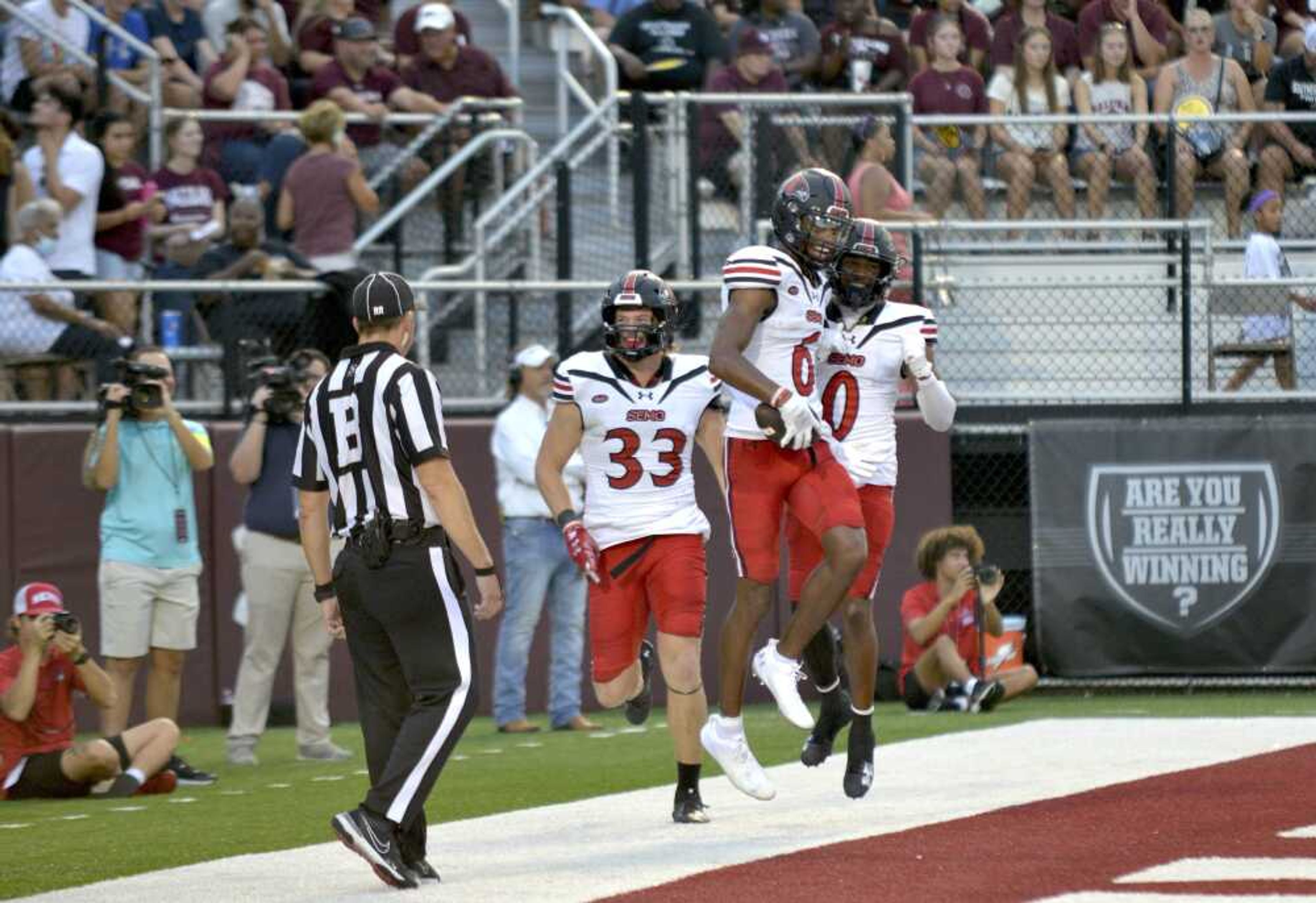 Southeast Missouri State receiver Dorian Anderson celebrates scoring a touchdown with receivers Mitchell Sellers, left, and Cam Pedro during the Redhawks' 38-21 win over Southern Illinois on Saturday, Sept. 21, in Carbondale, Ill.