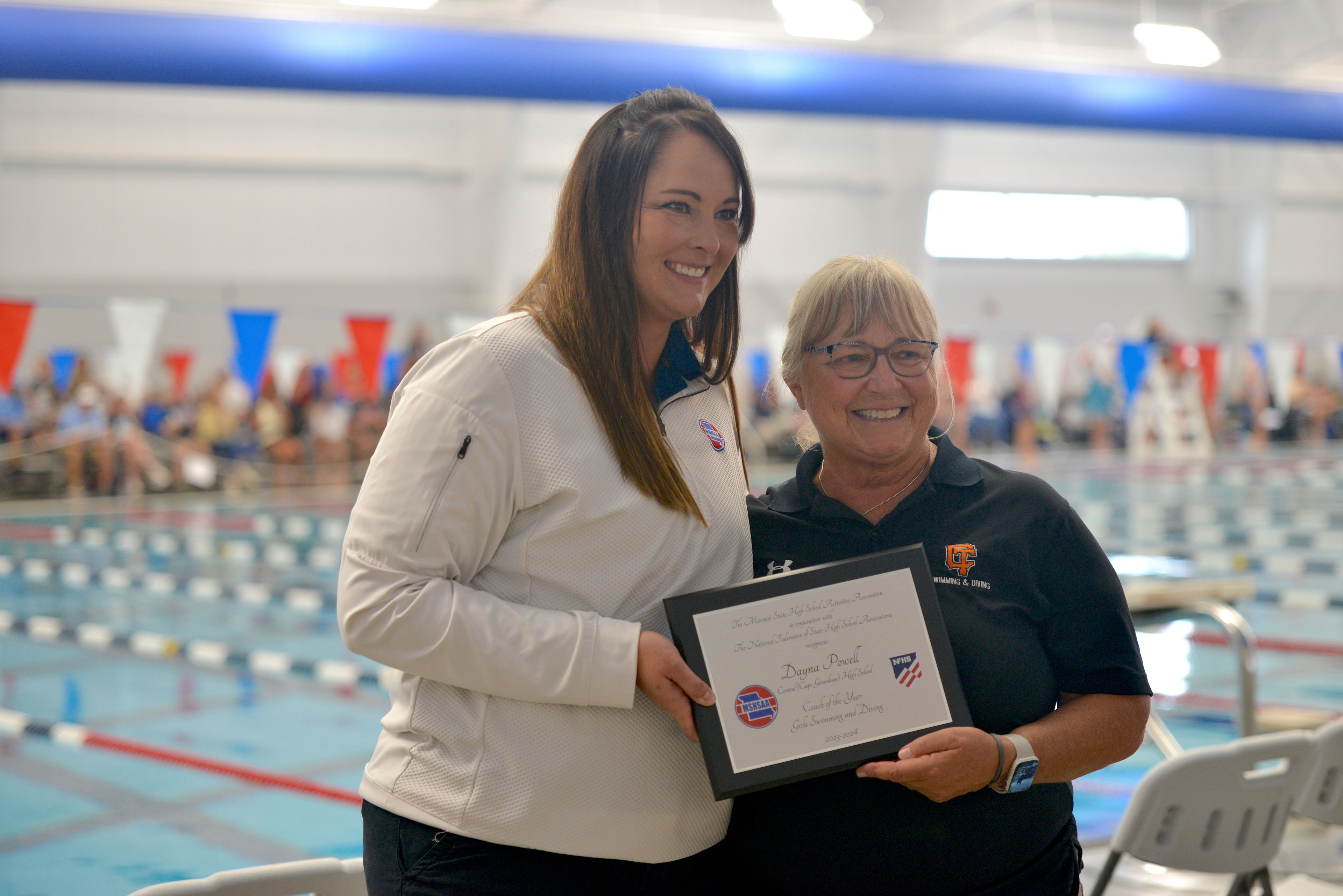 Cape Central swimming coach Dayna Powell, right, is presented with the 2023-24 Girls Swim & Dive MSHSAA Coach of the Year Award during Cape Rock on Saturday, Sept. 14, at the Cape Aquatic Center.