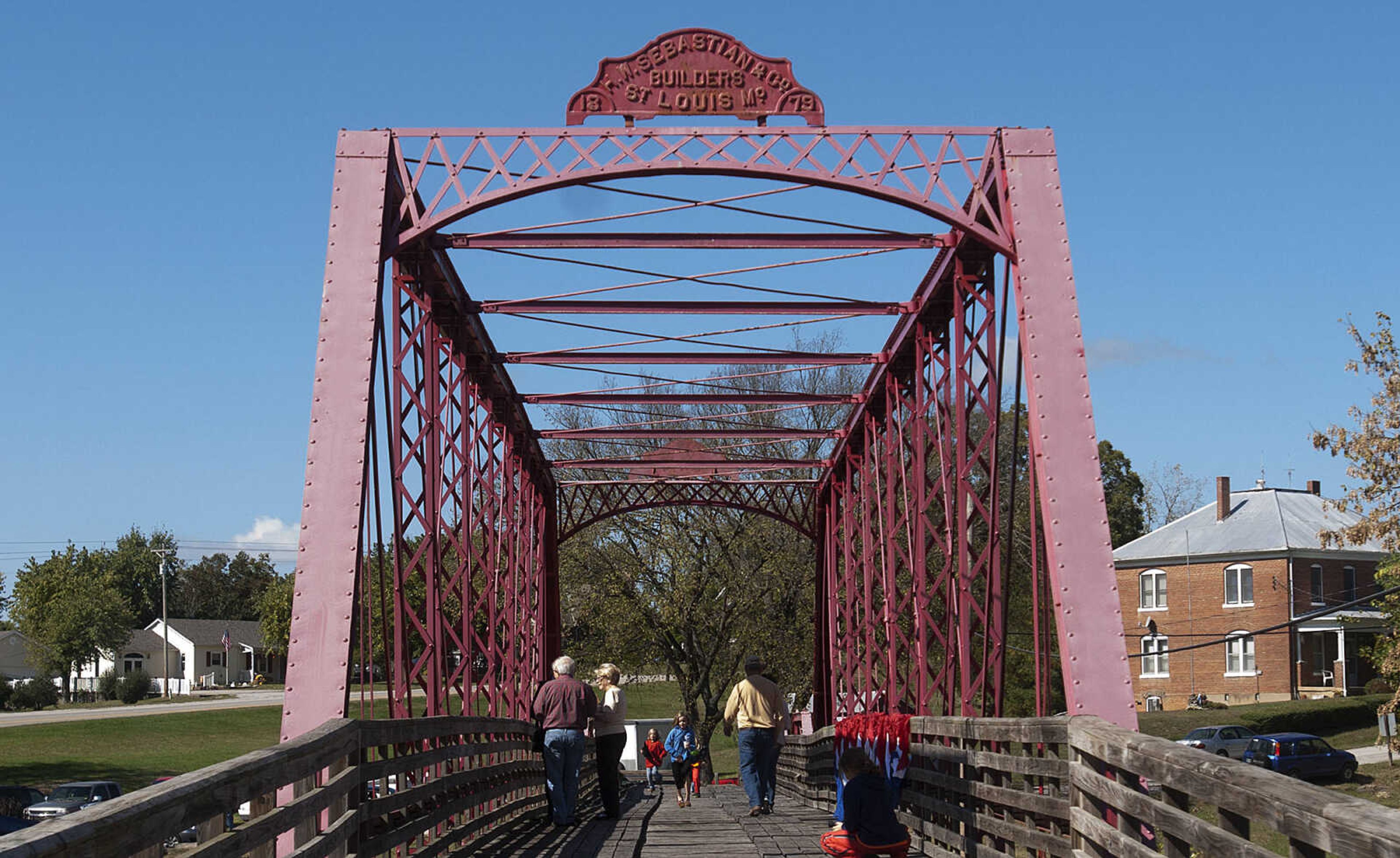 Attendees cross the bridge during the 2nd annual Old Appleton Fall Fest Saturday, Oct. 19, in Old Appleton, Mo. The festival featured arts, crafts and food as well as free rides on the Bucky Express for children.