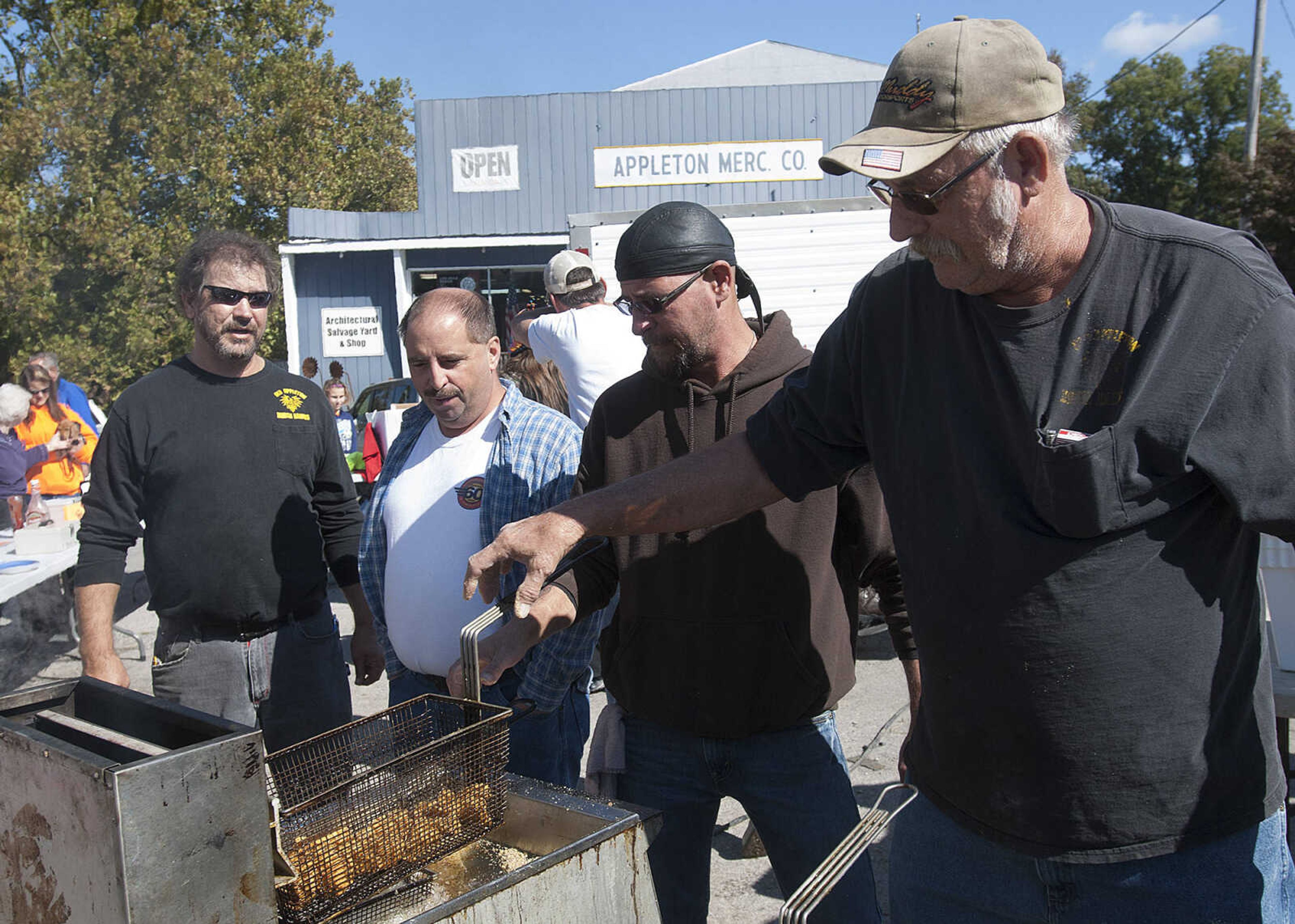 Members of the Old Appleton Brush Hawks fry fish and french fries during the 2nd annual Old Appleton Fall Fest Saturday, Oct. 19, in Old Appleton, Mo. The money raised by selling food at the festival will be used to provide Christmas food baskets for the less fortunate.