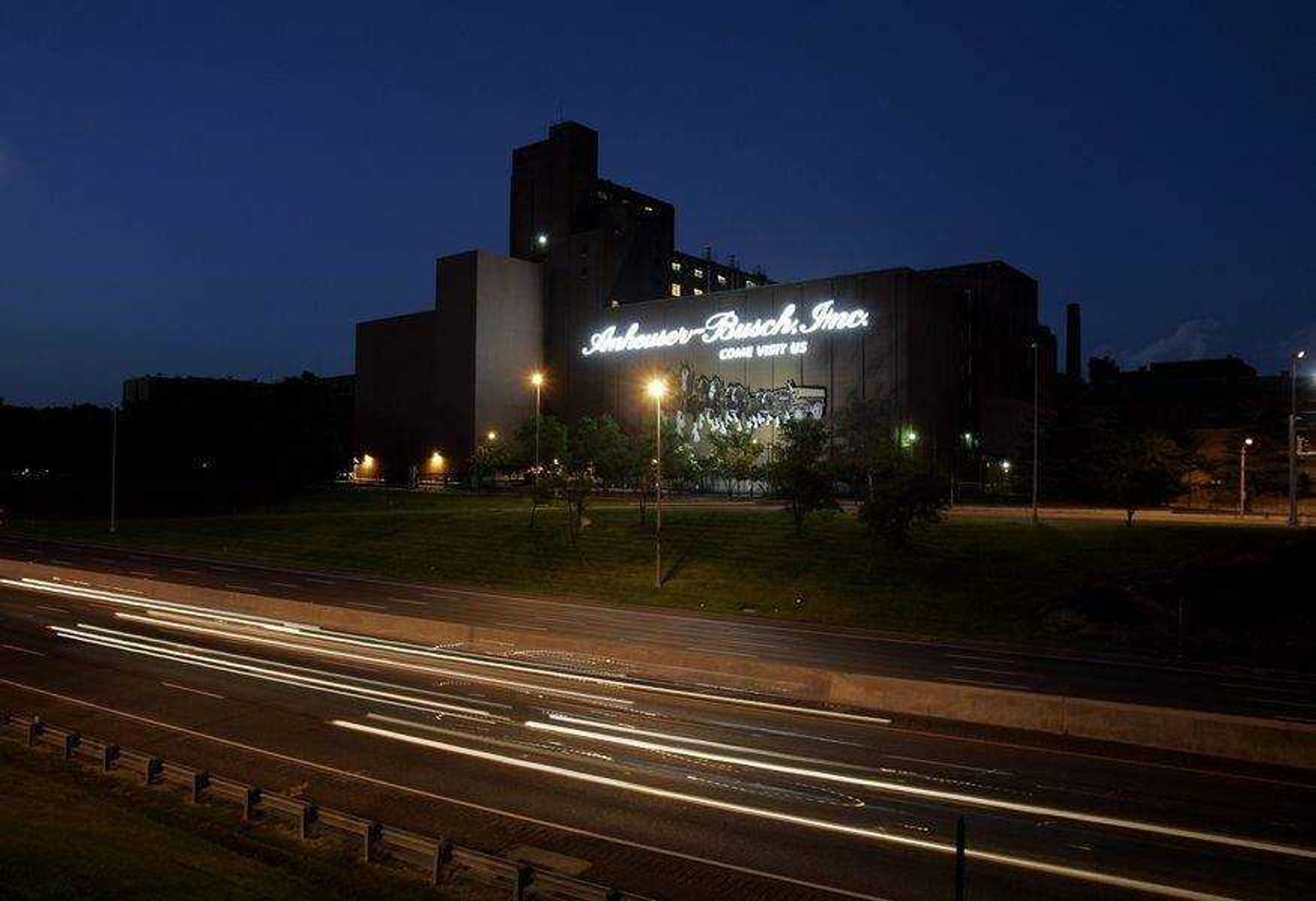 In this Monday, July 14, 2008 file photo, cars drive past the Anheuser-Busch brewery in St. Louis. The $52 billion sale of iconic St. Louis brewer Anheuser-Busch Cos. Inc. to InBev SA highlighted what was an overall difficult year for business in Missouri. InBev agreed to make St. Louis its North American headquarters, but the merger has already taken a toll -- 1,400 Anheuser-Busch workers, about 1,000 of them in St. Louis, saw their jobs eliminated 2 1/2 weeks before Christmas.(AP Photo/Jeff Roberson, File)