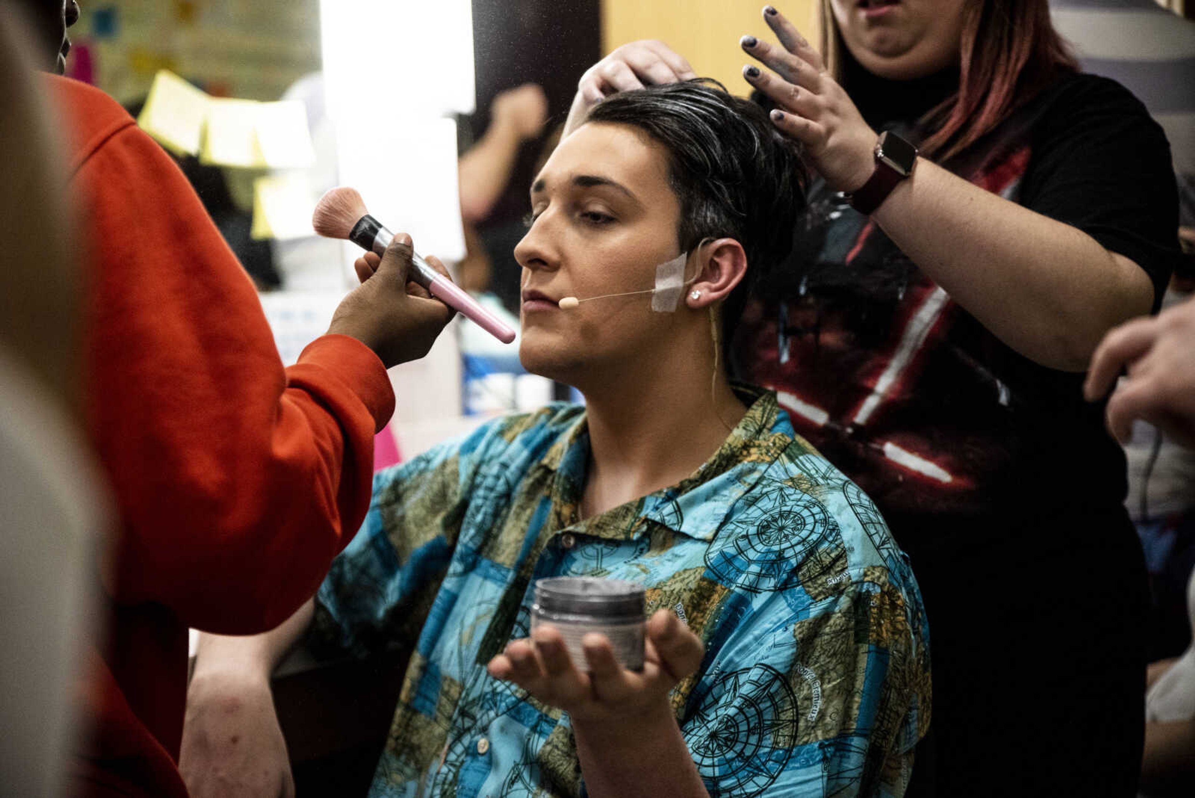 Russell Allen, 18, sits while hair and makeup crew members transform him into the character of Bill Austin during the media night of Cape Central High School's spring musical production of "Mamma Mia!" Wednesday, April 10, 2019, in Cape Girardeau.