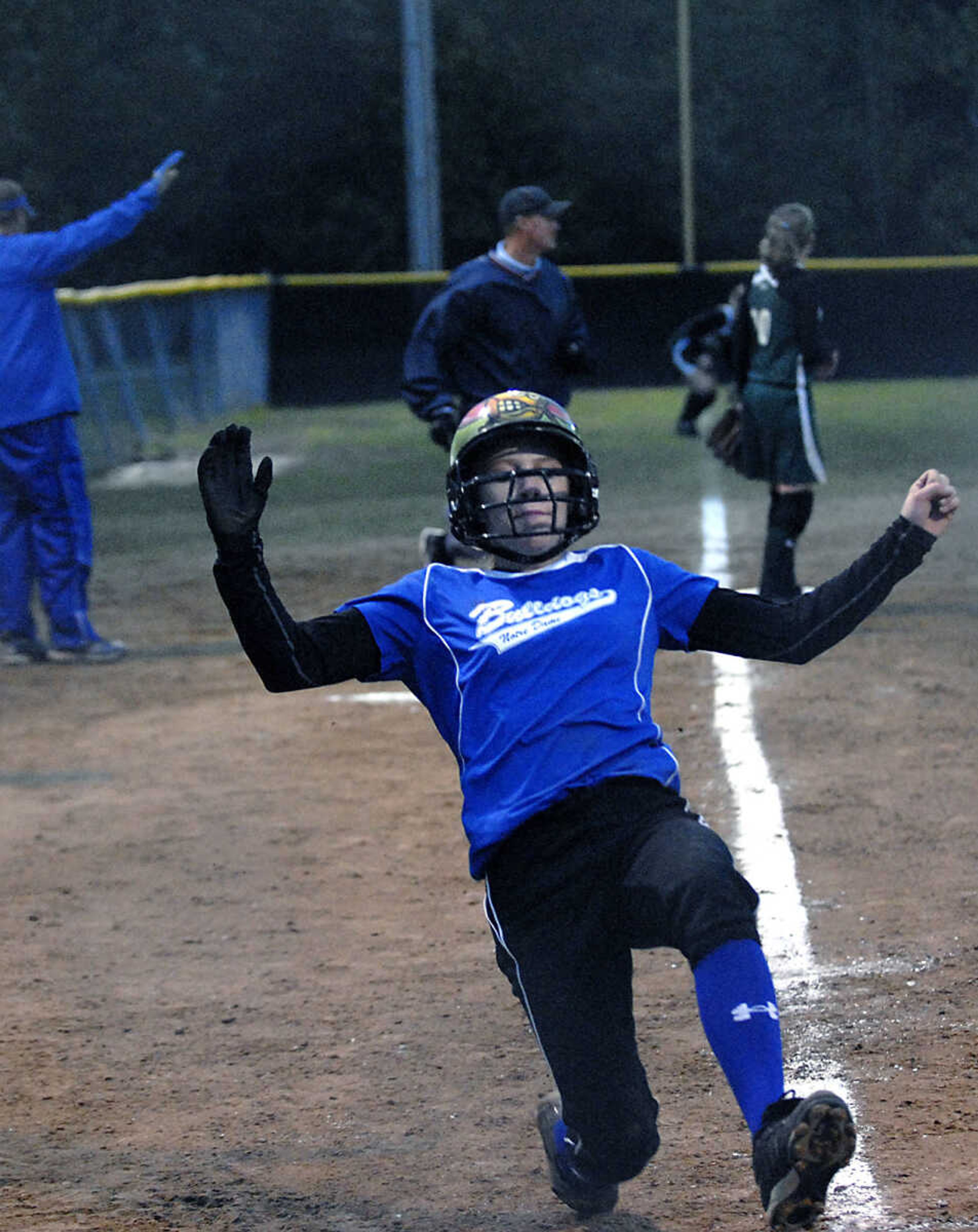 KIT DOYLE ~ kdoyle@semissourian.com
Notre Dame's Summer Burger slides into home for a run Thursday, October 15, 2009, in Poplar Bluff.