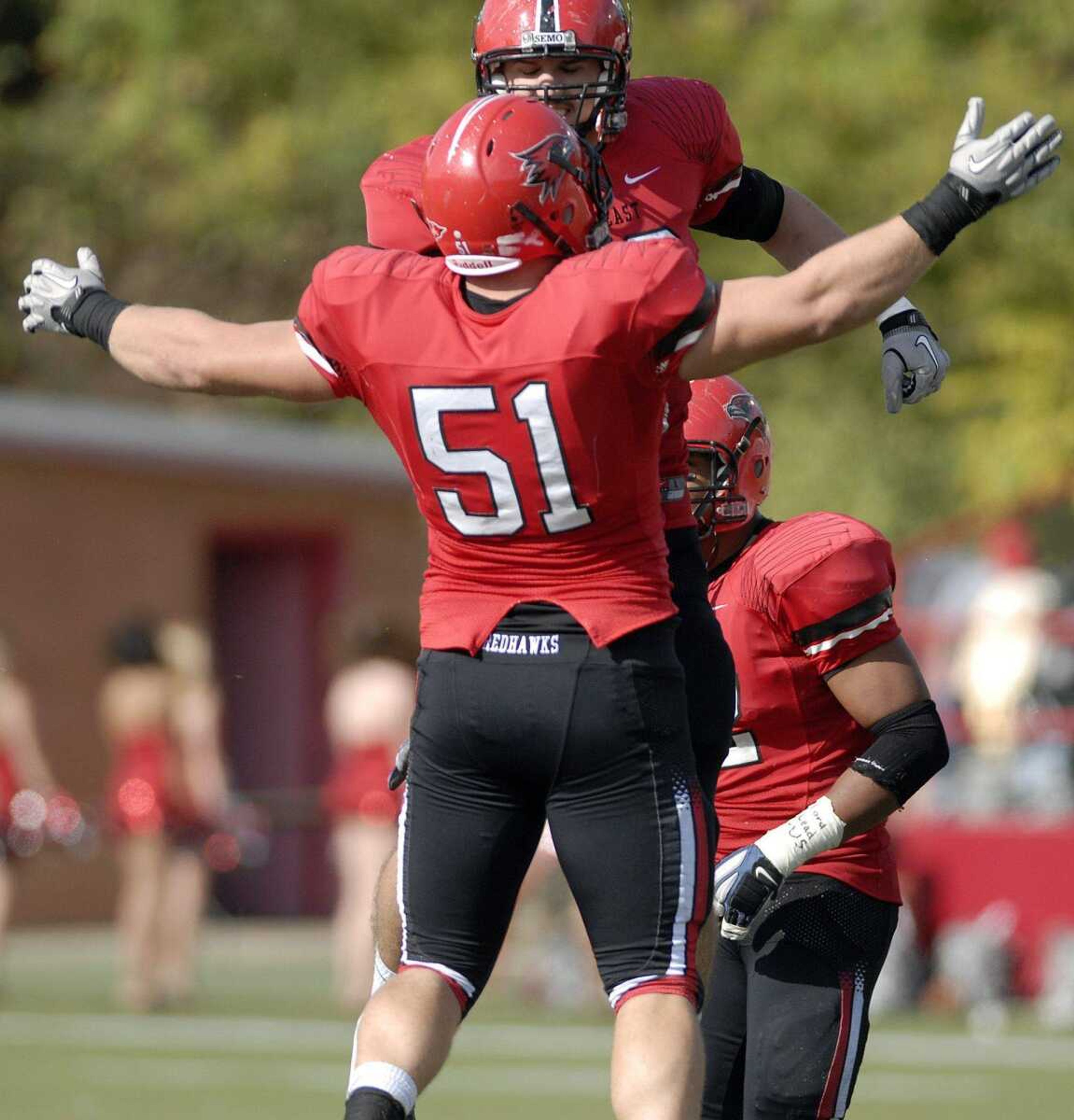 Southeast Missouri State's Steve Hendry (51) congratulates Darrick Borum after a play during Saturday's game at Houck Stadium. The Redhawks defeated Eastern Kentucky 40-21. (Laura Simon)