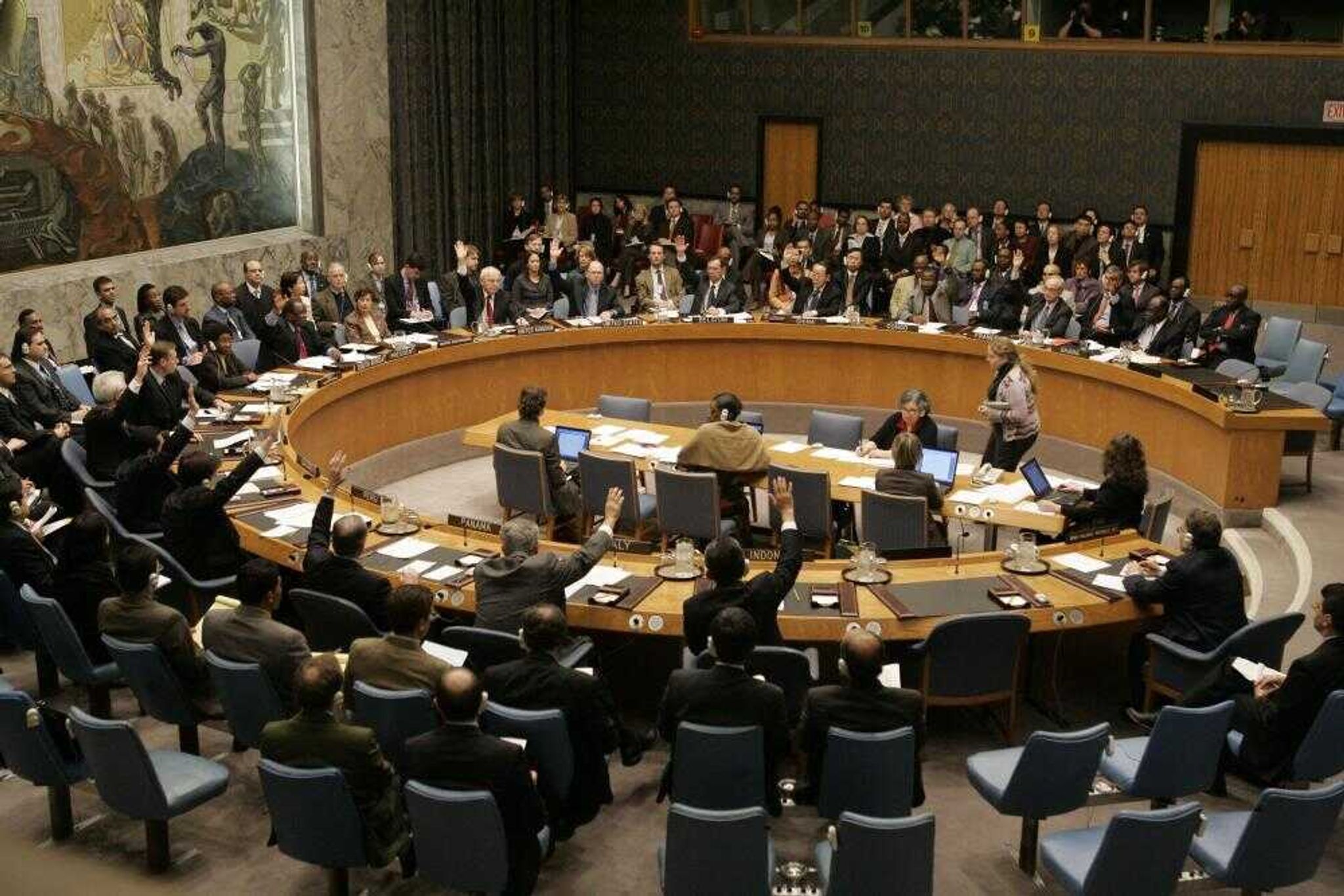 The United Nations Security Council voted unanimously Saturday to expand sanctions against Iran at United Nations headquarters. The sanctions would ban Iranian arms exports and freeze the assets of 28 additional individuals and organizations involved in Iran's nuclear and missile programs. About a third of those are linked to the Revolutionary Guard, an elite military corps. (MARY ALTAFFER ~ Associated Press)