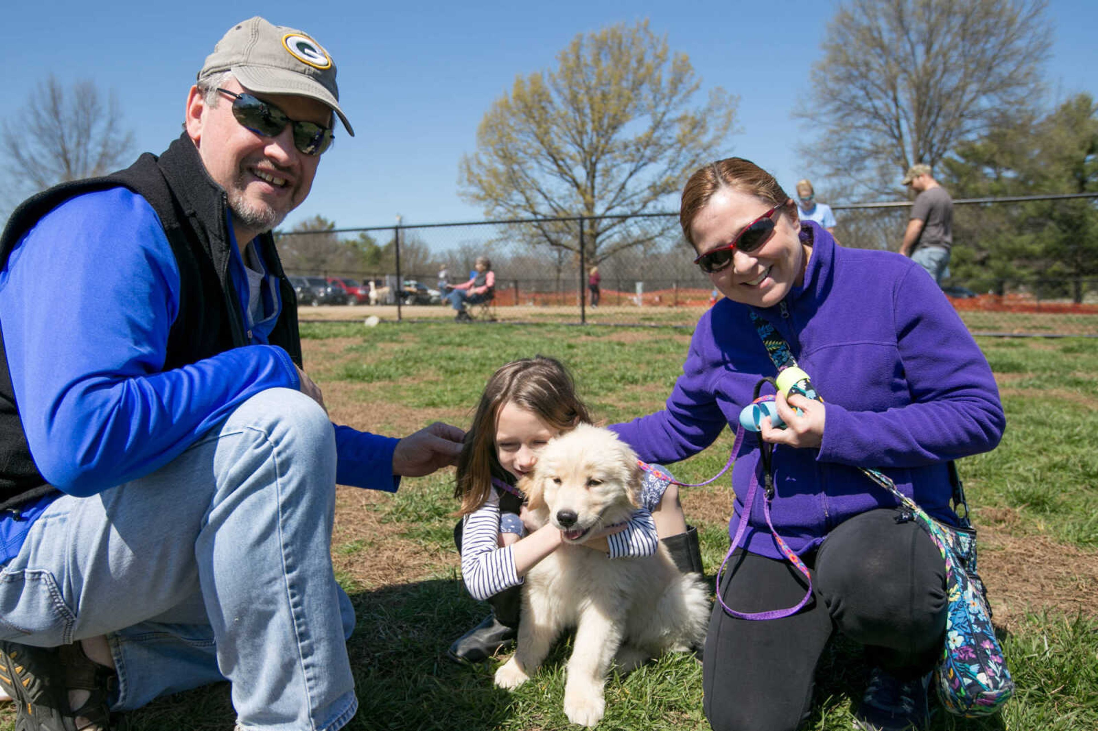 GLENN LANDBERG ~ glandberg@semissourian.com

Hugh, Julia and Sarah McGowan pose for a photo with Rosebud after the Peeps for Paws dog Easter egg hunt at Dog Town in Kiwanis Park, Saturday, March 26, 2016.