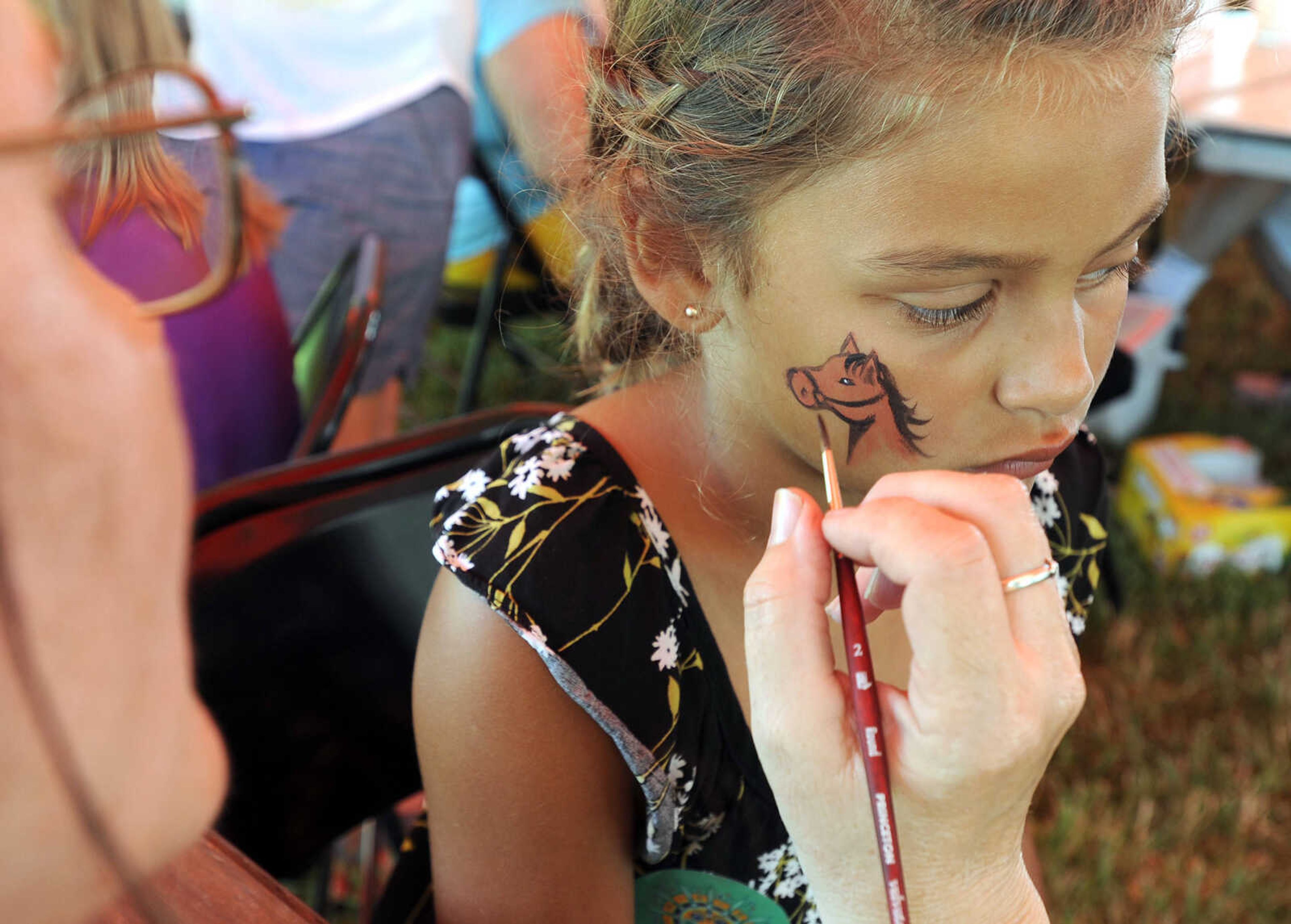 FRED LYNCH ~ flynch@semissourian.com
Swayze Darter gets her face painted by Vickie Bollinger on Saturday, June 16, 2018 at the Summer Arts Festival at the River Campus.