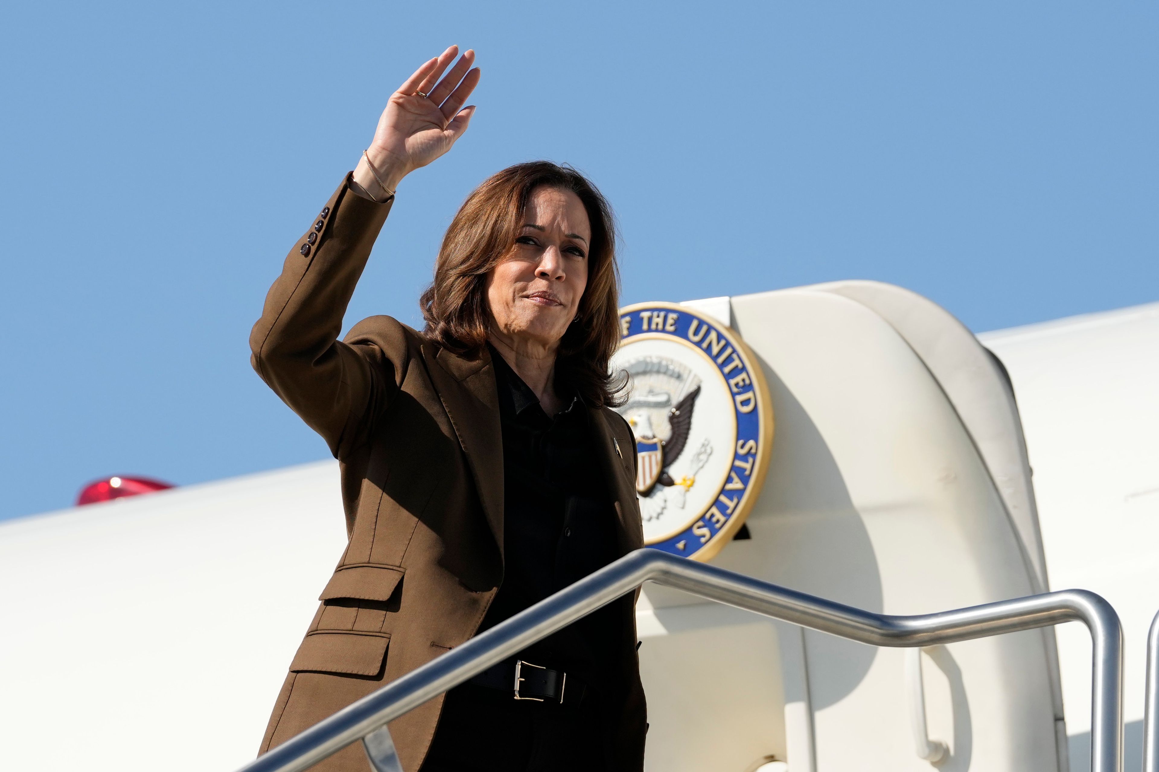 Democratic presidential nominee Vice President Kamala Harris waves as she boards Air Force Two, Friday, Oct. 11, 2024, at Sky Harbor International Airport in Phoenix, en route to Washington. (AP Photo/Ross D. Franklin)