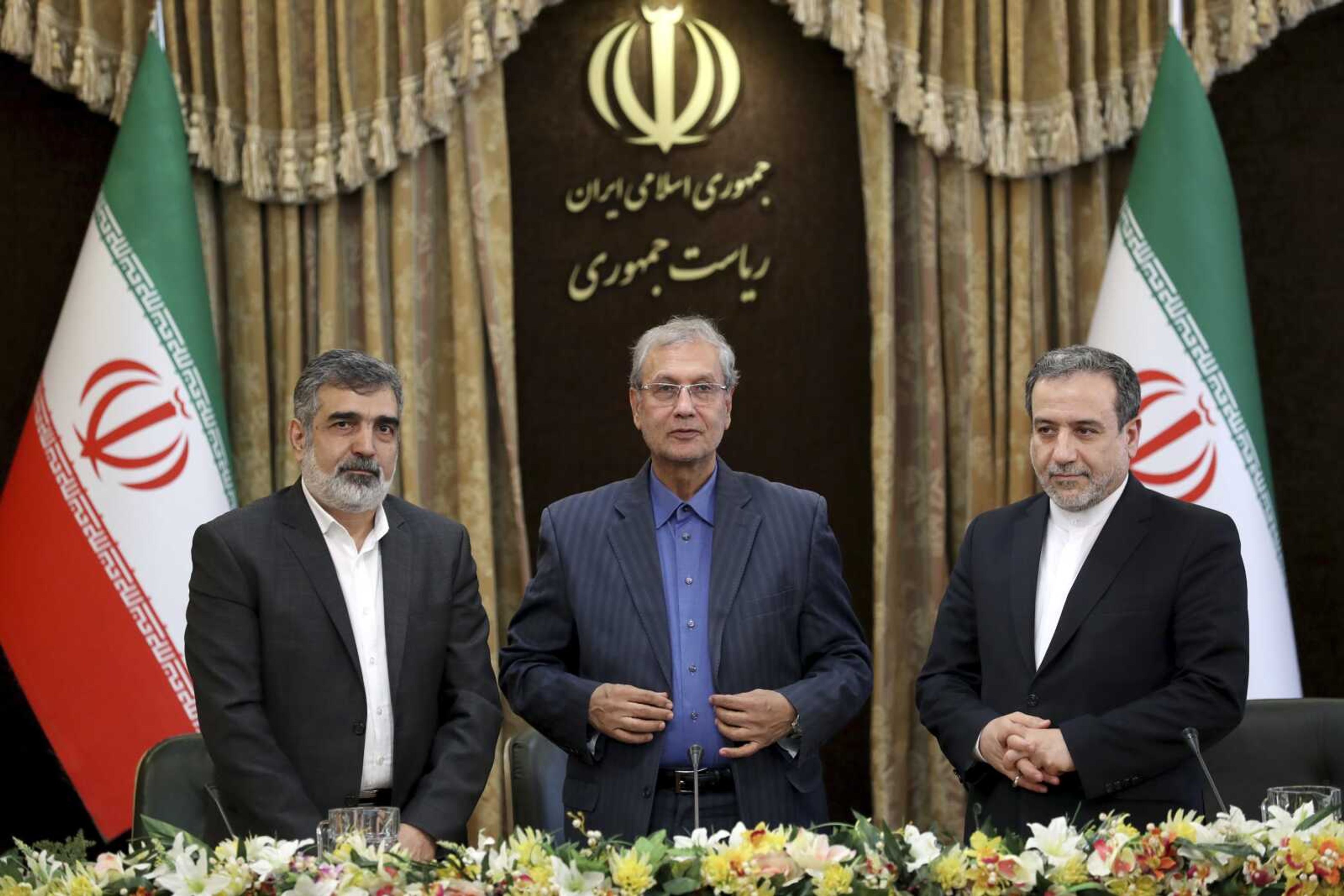 From left to right, spokesman for Iran's atomic agency Behrouz Kamalvandi, Iran's government spokesman Ali Rabiei and Iranian Deputy Foreign Minister Abbas Araghchi, attend a news briefing Sunday in Tehran, Iran. The deputy foreign minister said Iran considers the 2015 nuclear deal with world powers to be a "valid document" and seeks its continuation.