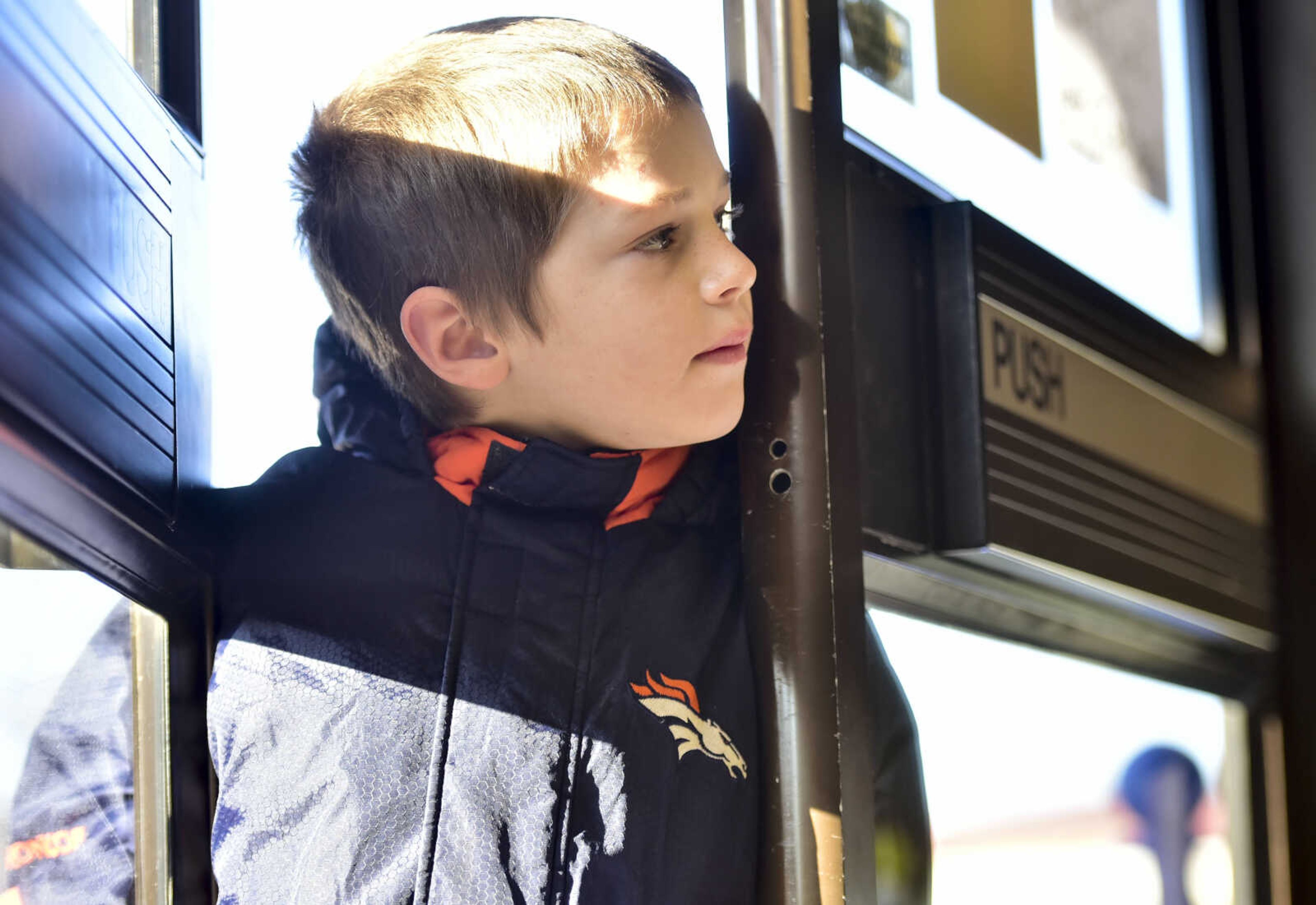 Ryan Munroe, 8, peeks through Elks Lodge #2652 while waiting for the doors to formally open Friday, Dec. 15, 2017, in Jackson.