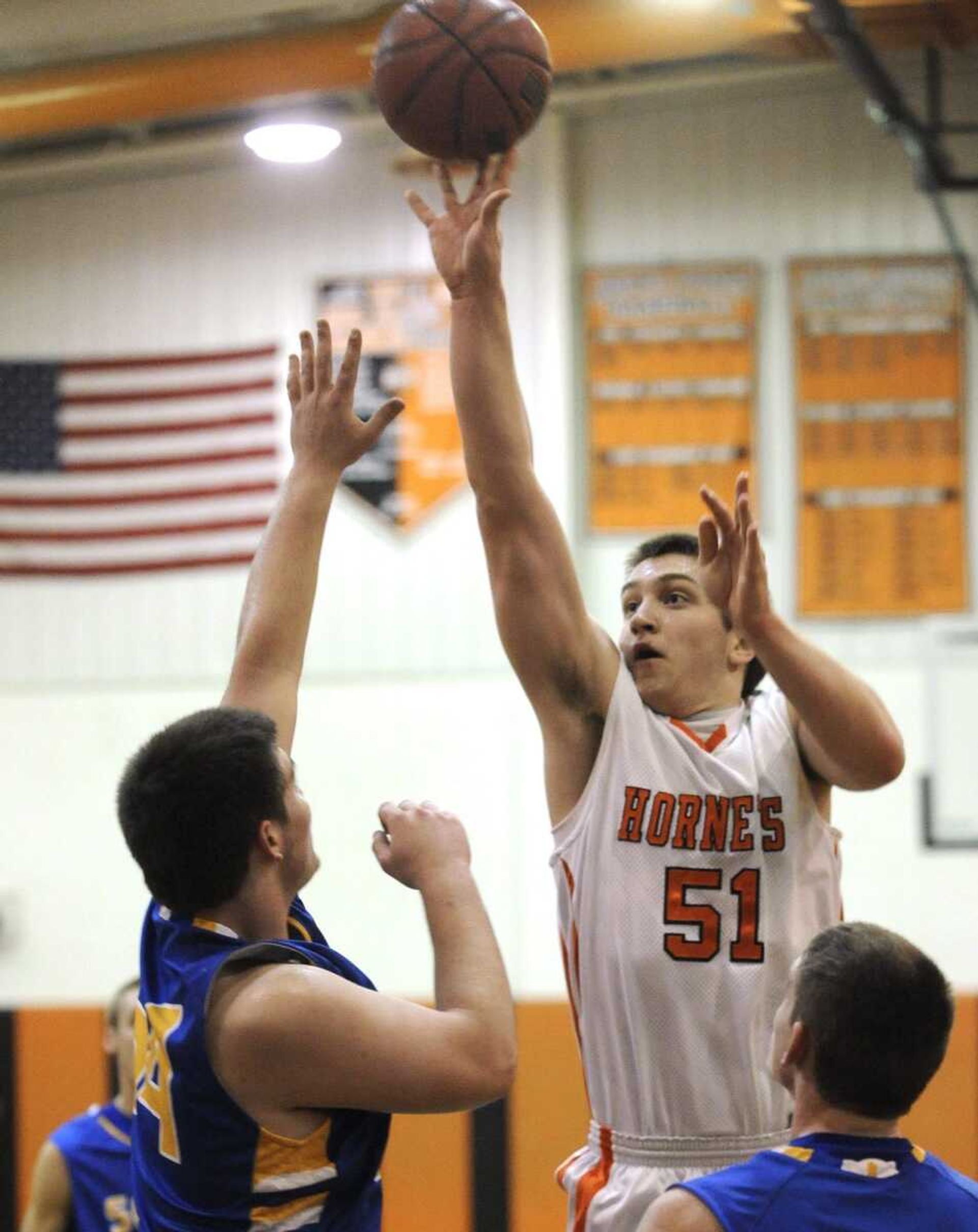 Advance's Ethan Barr shoots over Scott City's Ryan Fortner during the first quarter Friday.