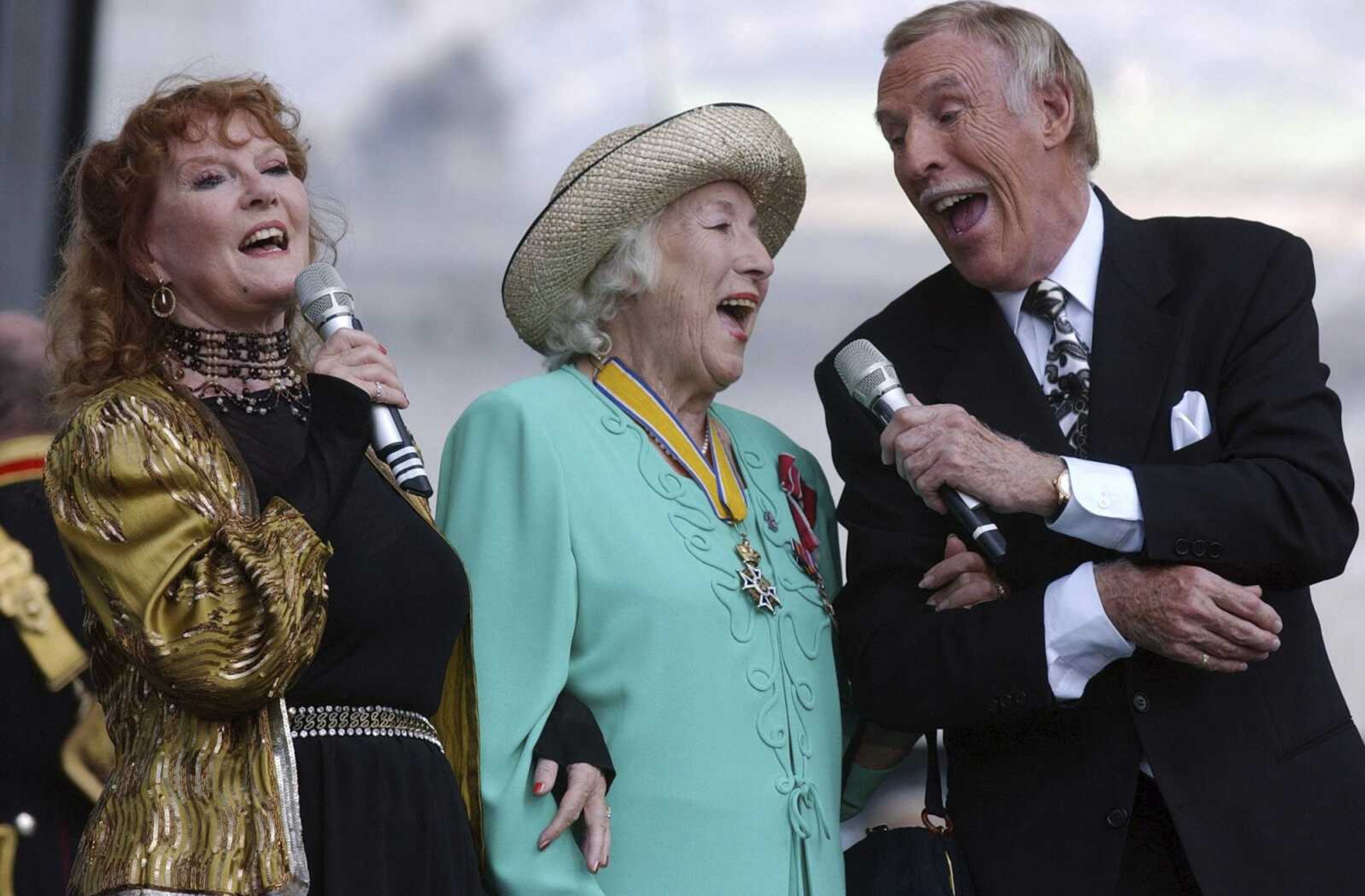 Dame Vera Lynn, center,  singer Petula Clark, left, and entertainer Bruce Forsyth sing "We'll Meet Again" during the World War II 60th Anniversary Service July 10, 2005, at Horse Guards Parade in London.