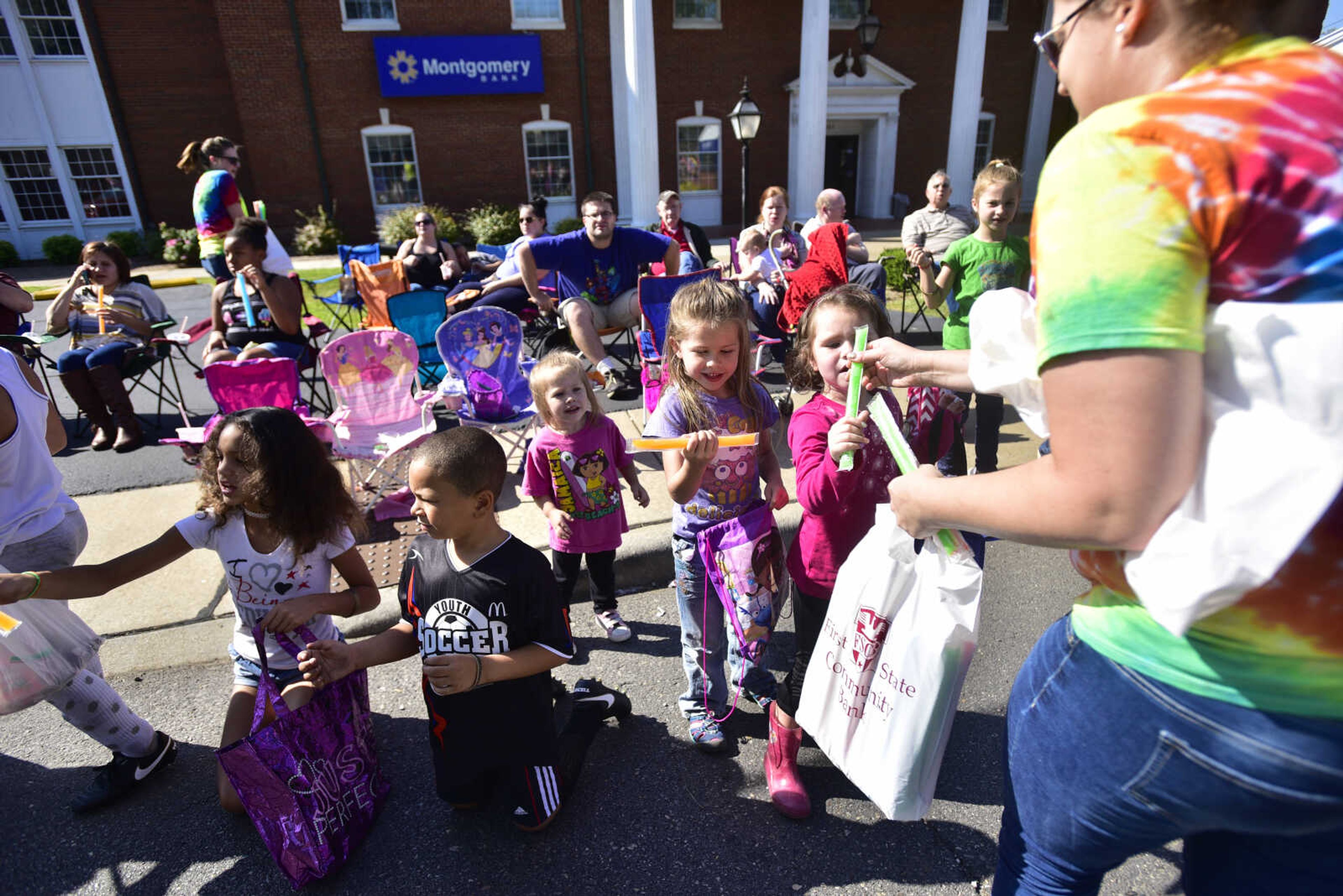 Kids are handed freeze pops during the SEMO District Fair parade Saturday, Sept. 9, 2017 in Cape Girardeau.