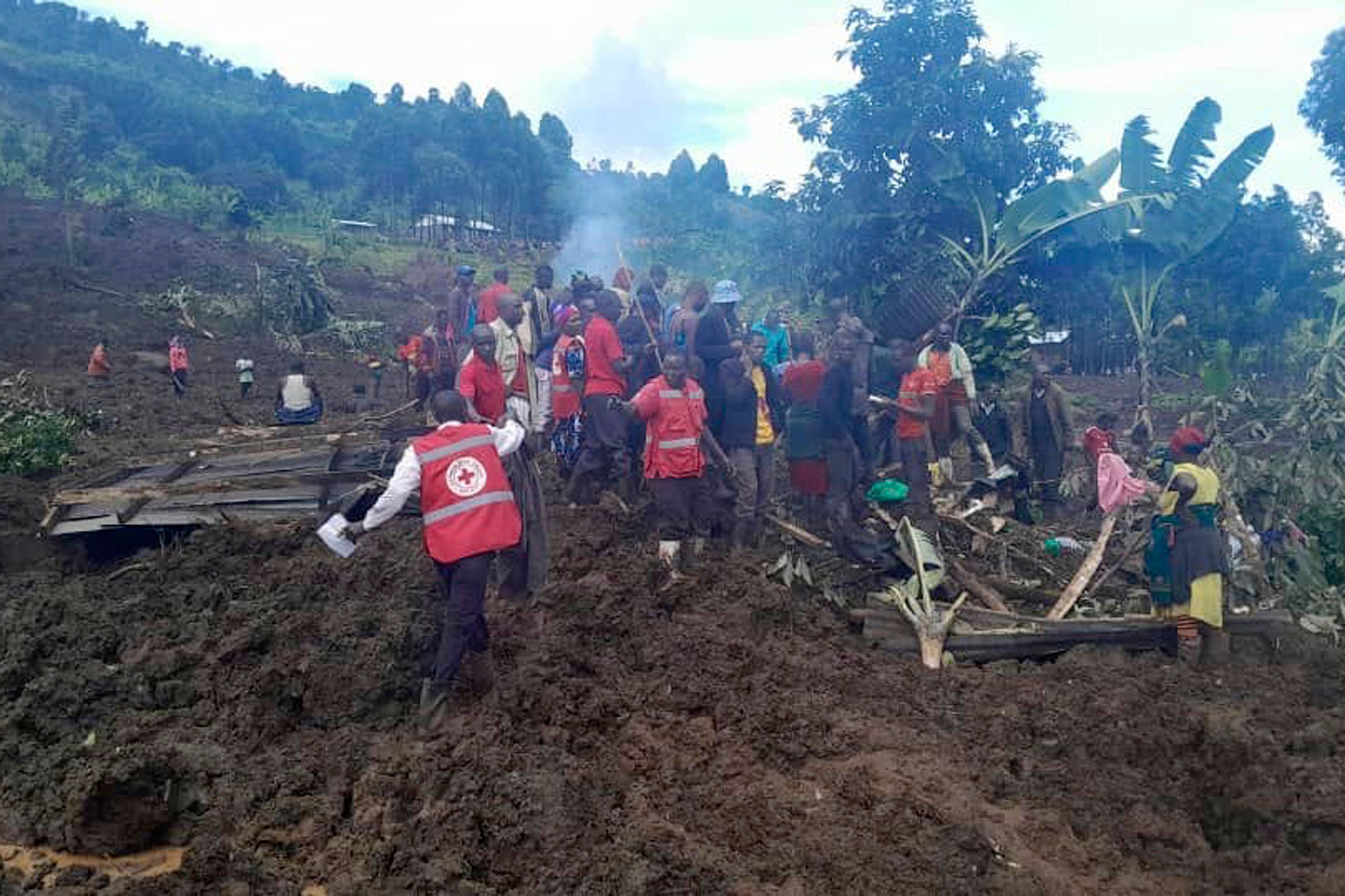 Uganda Red Cross workers search for bodies after a landslide following heavy rains buried 40 homes in the mountainous district of Bulambuli, eastern Uganda, Thursday, Nov. 28. 2024. (AP Photo/Irene Nakasiita)