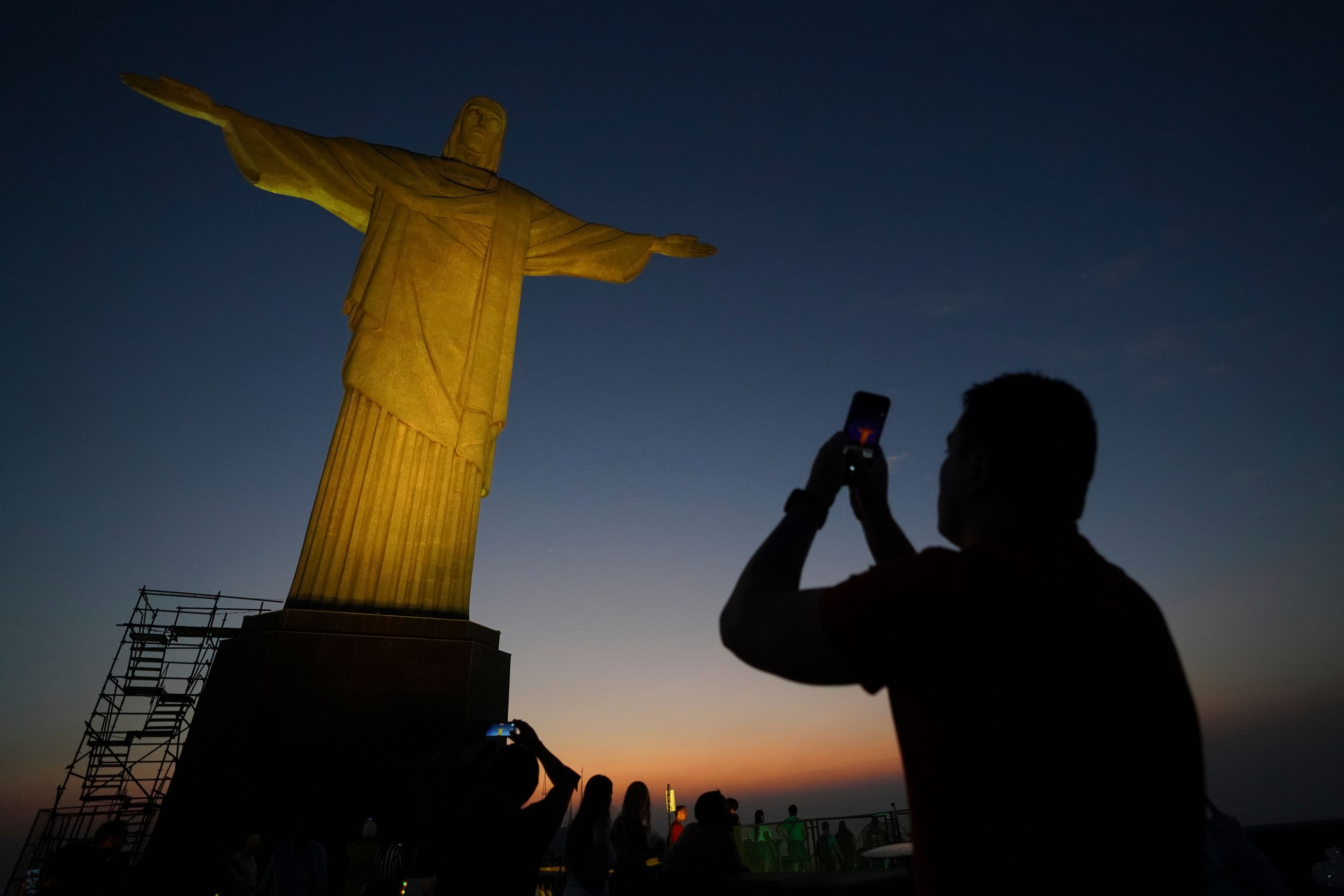 A tourist takes a photo of the Christ the Redeemer statue in Rio de Janeiro, Tuesday, Sept. 10, 2024. (AP Photo/Hannah-Kathryn Valles)