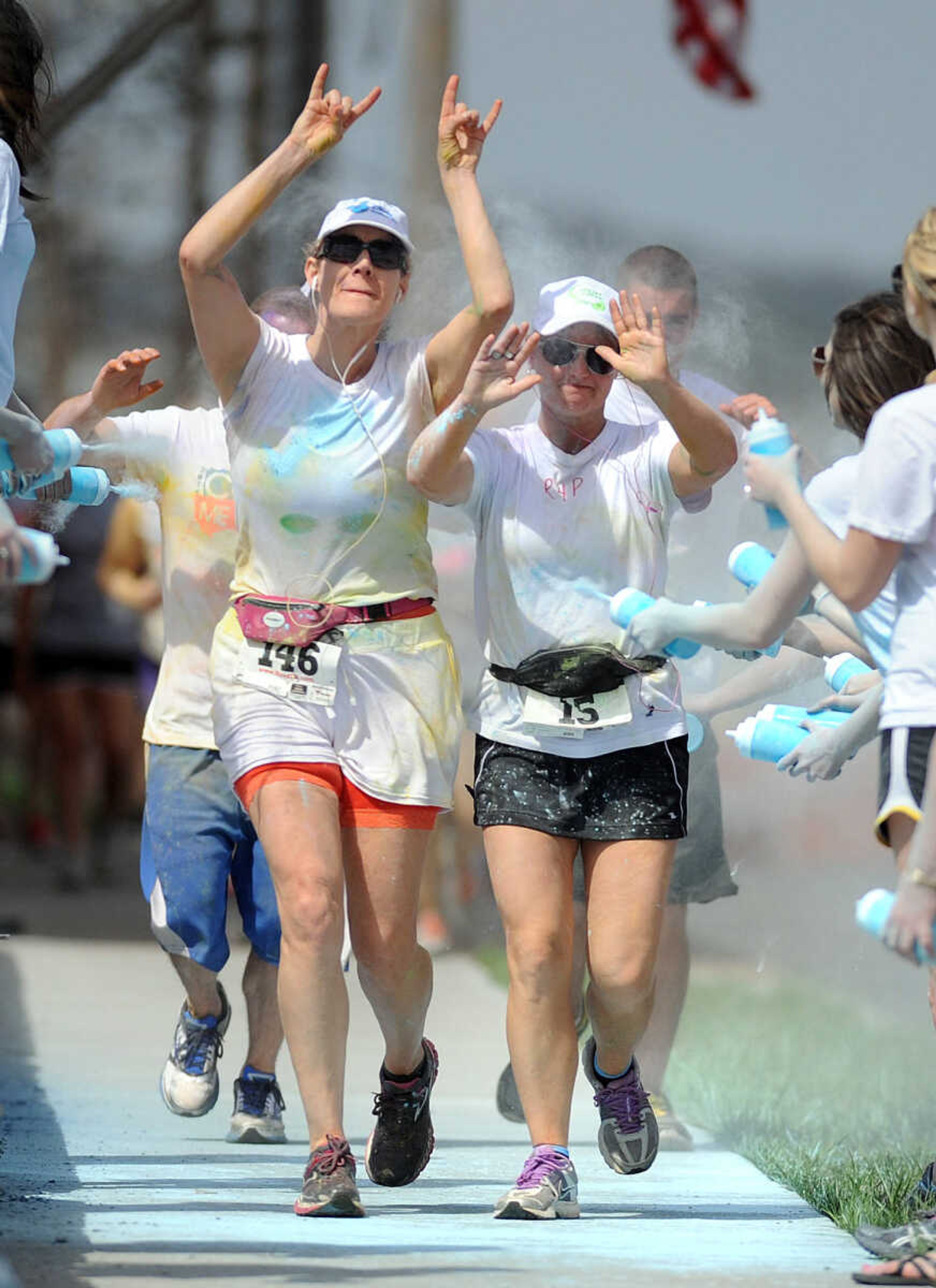 LAURA SIMON ~ lsimon@semissourian.com

Participants in the Color Me Cape 5K are sprayed with blue powder at the final color station on Main Street, Saturday, April 12, 2014, in Cape Girardeau.