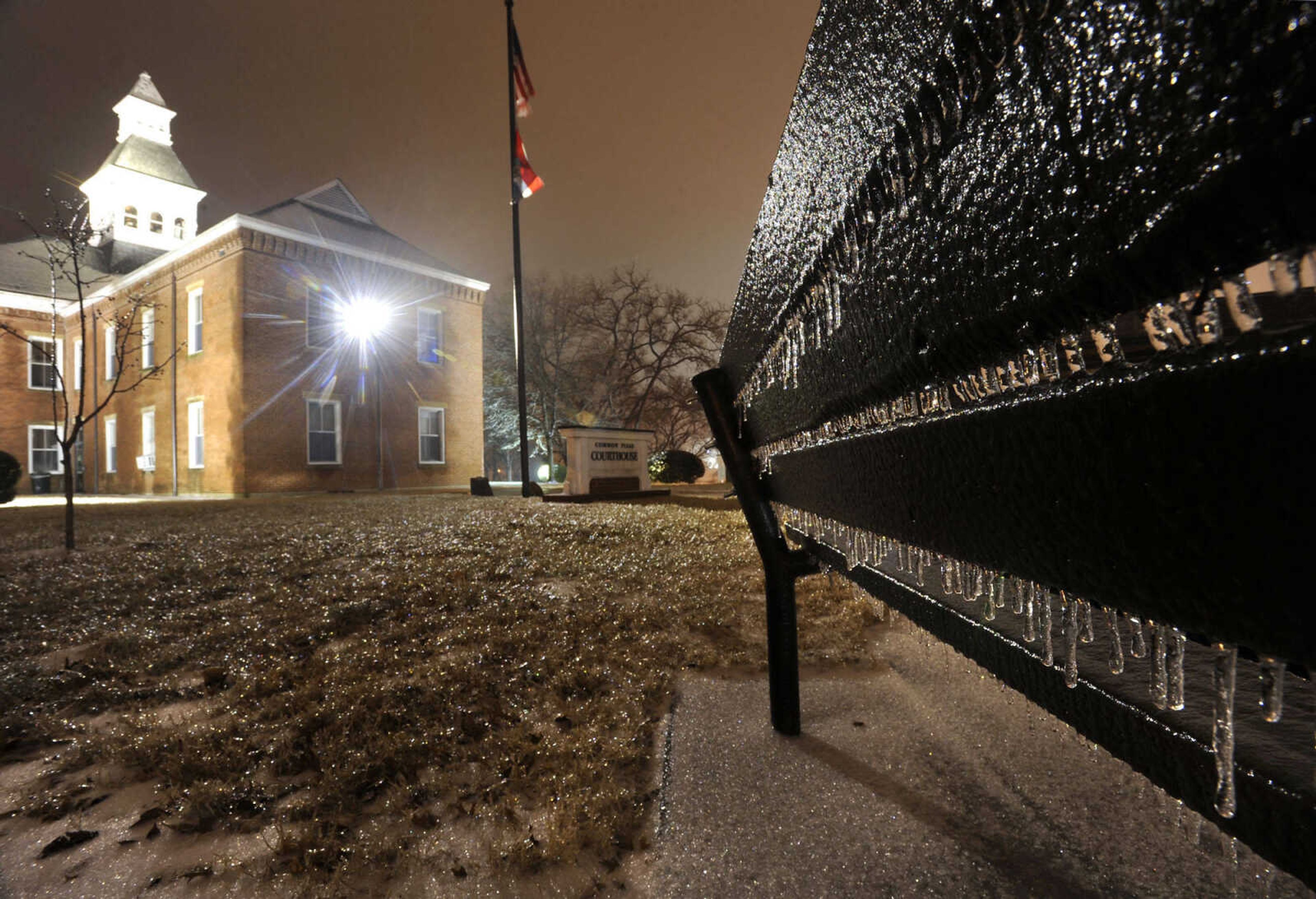 FRED LYNCH ~ flynch@semissourian.com
Freezing rain leaves its mark on a park bench in Common Pleas Courthouse Park as temperatures fall Tuesday evening, Feb. 4, 2014 in Cape Girardeau.