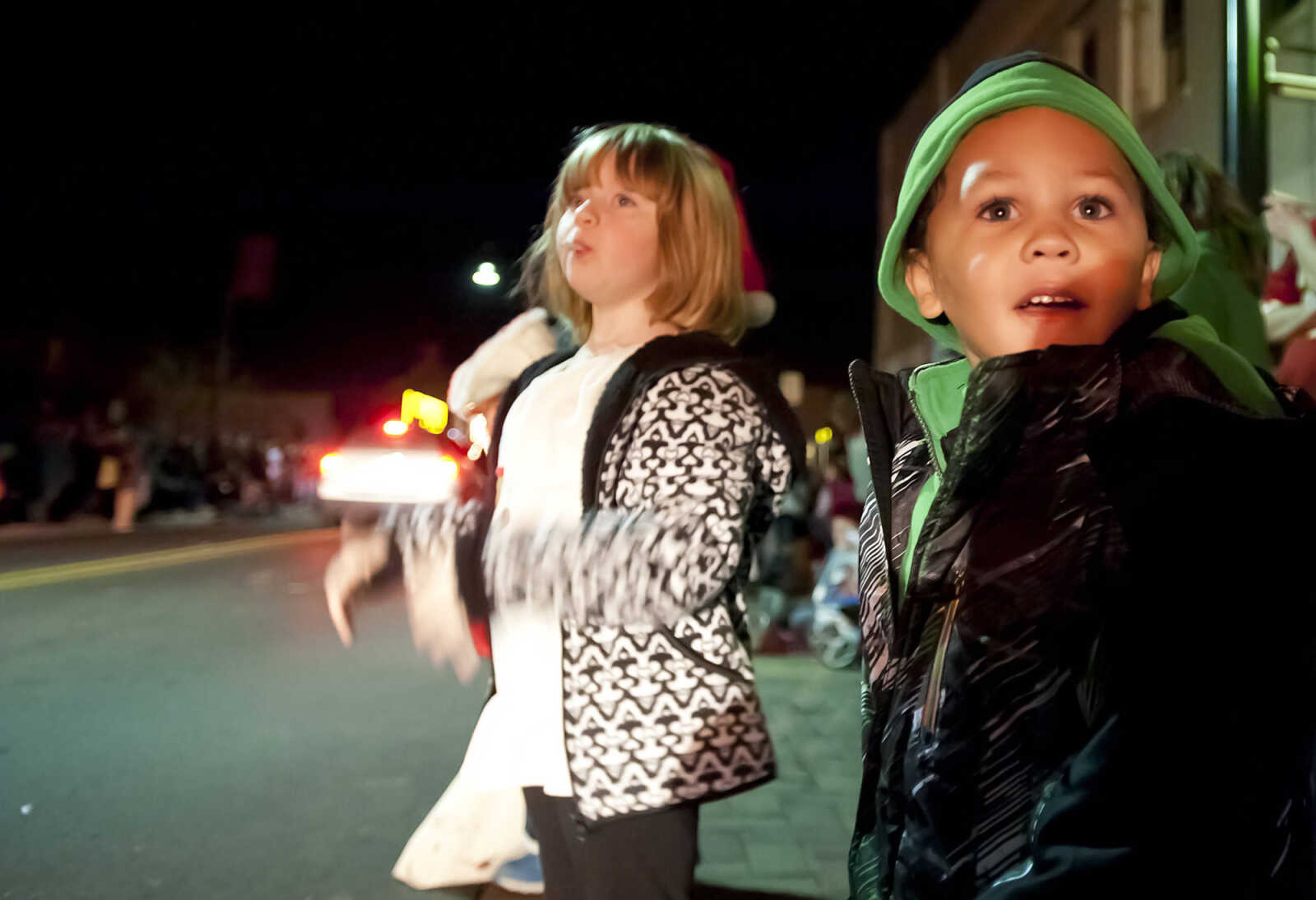 Lola Karlish, 4, left, and Kingston Wade, 3, watch as floats travel down Broadway during the 22nd Annual Parade of Lights Sunday, Dec. 1, in Cape Girardeau. The parade started at Capaha Park making its way down Broadway and Main Street. The theme for this year's parade was ŇChristmas Fun for Everyone.Ó