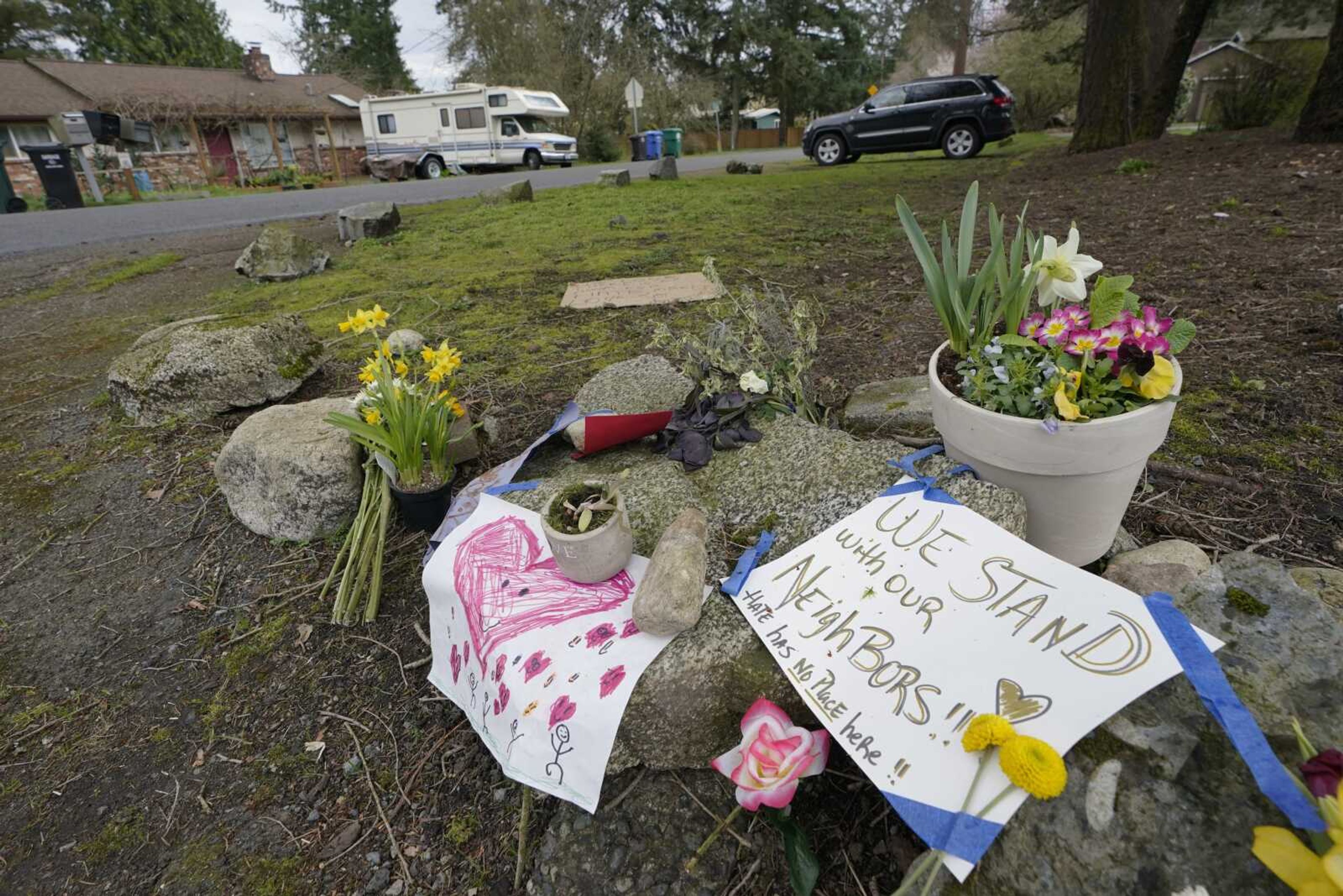 Flowers and messages of support are shown near the International Full Gospel Fellowship church, Thursday, March 18, 2021, in Seattle. The church was one of two in the neighborhood that were hit with anti-Asian graffiti earlier in the week, one of several incidents targeting Asian neighborhoods in Seattle this year. Asian Americans were already worn down by a year of pandemic-fueled racist attacks when a white gunman was charged with killing eight people, most of them Asian women, at three Atlanta-area massage parlors on Tuesday. (AP Photo/Ted S. Warren)