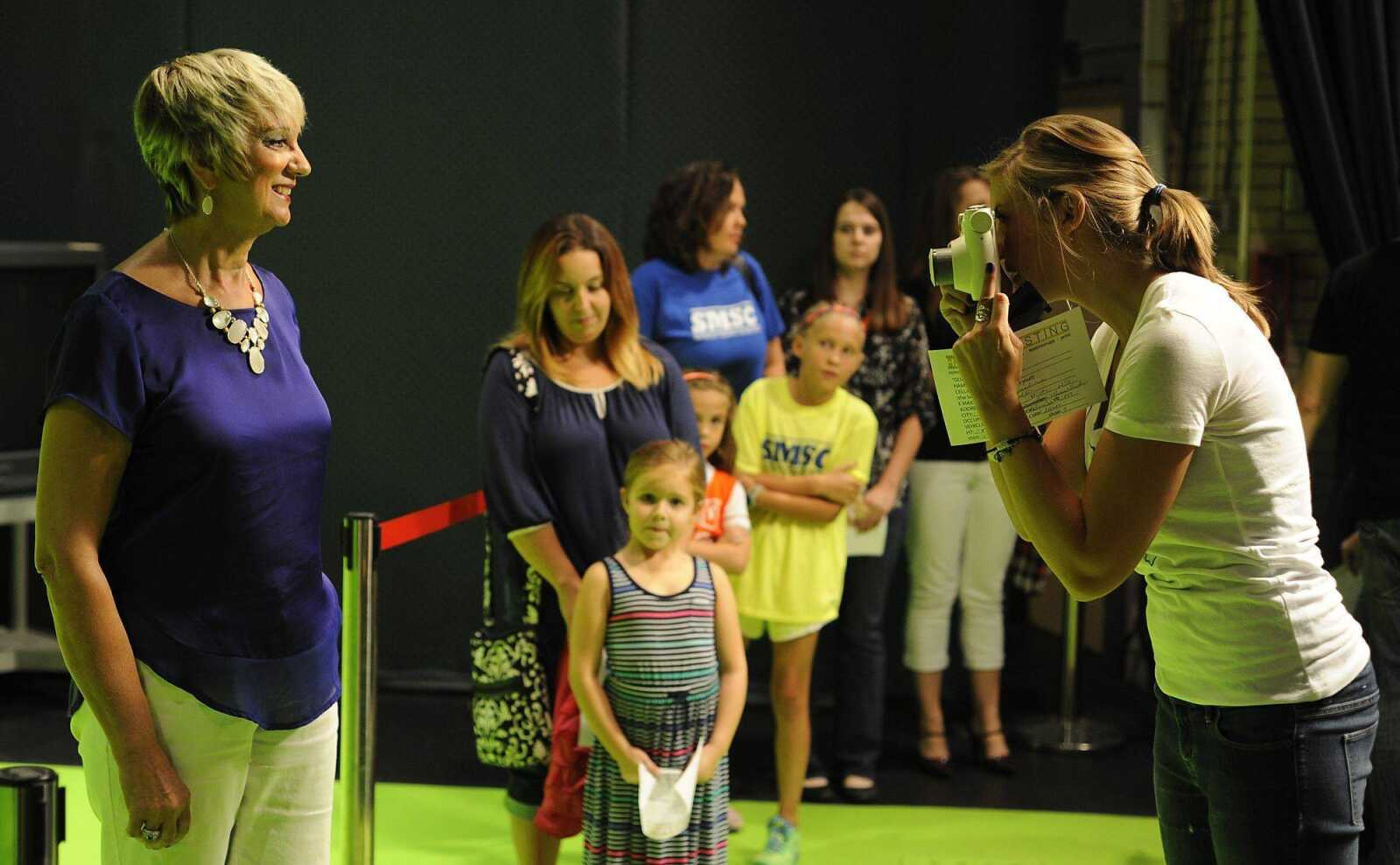 Jamie Schuette, right, takes a photo of Jean Ann Burke during a casting call Saturday for the feature film &#8220;Gone Girl&#8221; at the Rose Theatre at Southeast Missouri State University. More photos may be seen in a gallery at <i>semissourian.com.</i> (Adam Vogler)