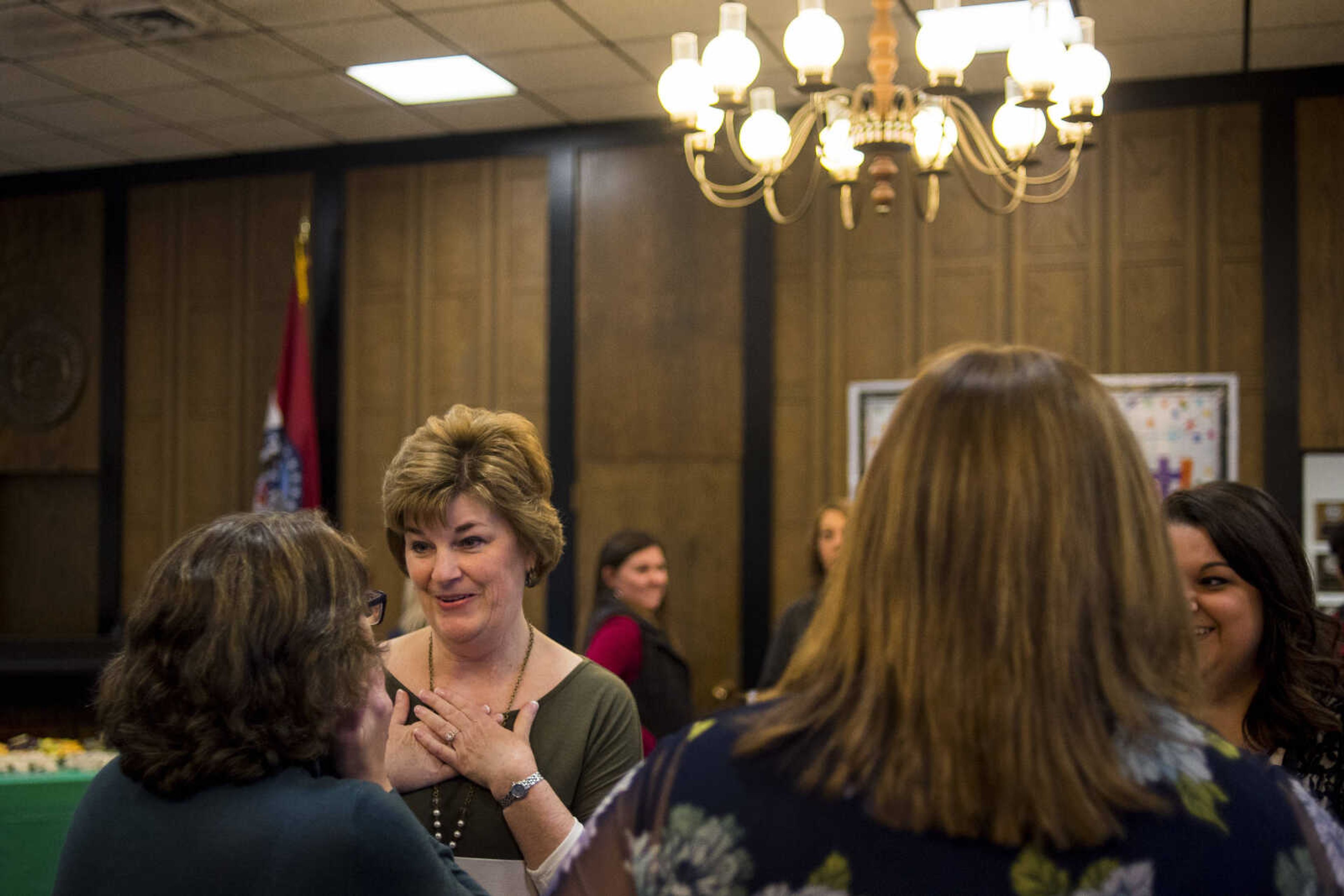 Patti Wibbenmeyer, center, reacts to being congratulated by a colleague Friday during a retirement party at the Cape Girardeau County Courthouse in Jackson to mark the end of Wibbenmeyer's 37 years as a court clerk, including eight years as Cape Girardeau County circuit clerk.