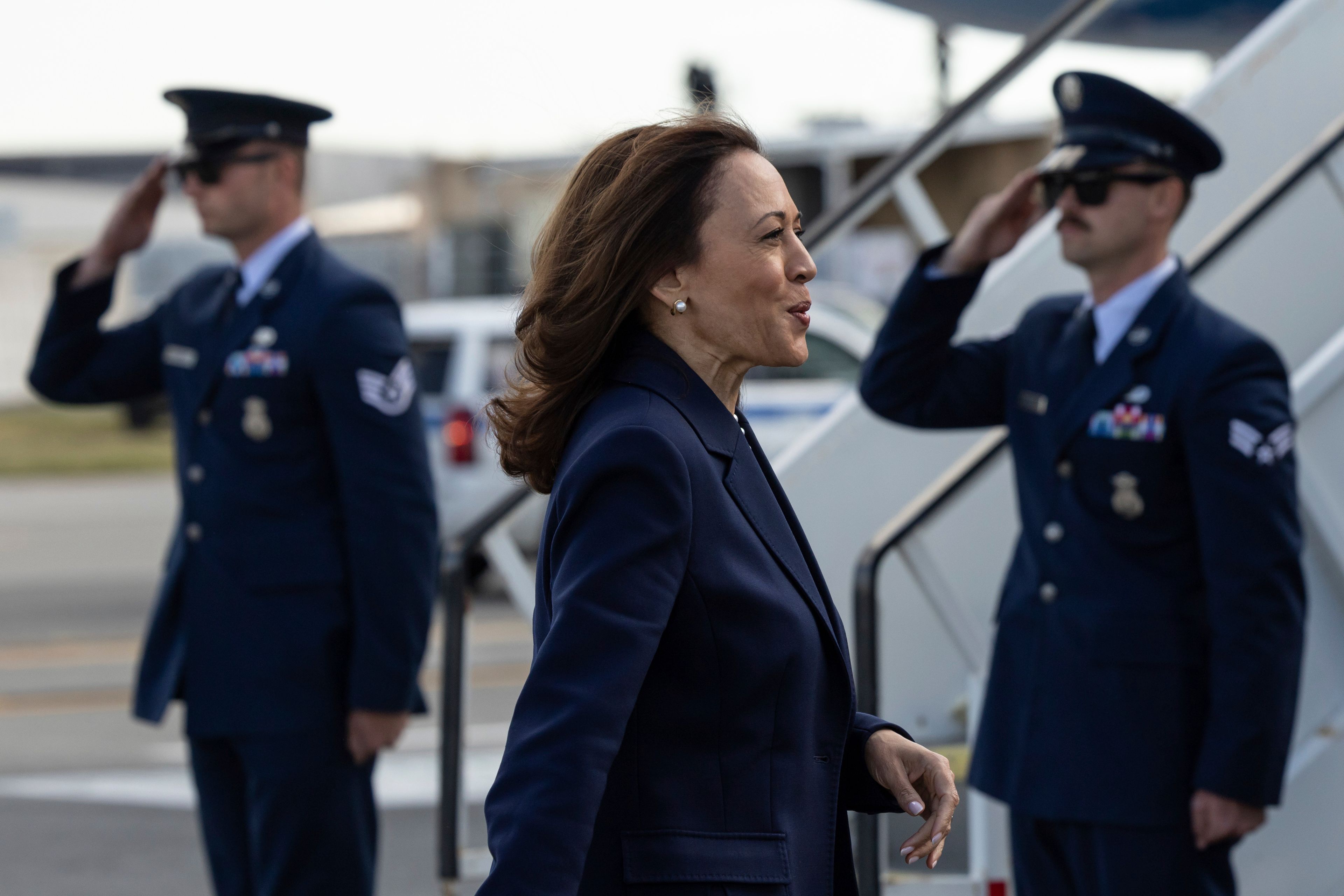 Democratic presidential nominee Vice President Kamala Harris walks to take pictures with volunteers before boarding Air Force Two at LaGuardia International Airport, Wednesday, Oct. 9, 2024, in New York. (AP Photo/Yuki Iwamura)