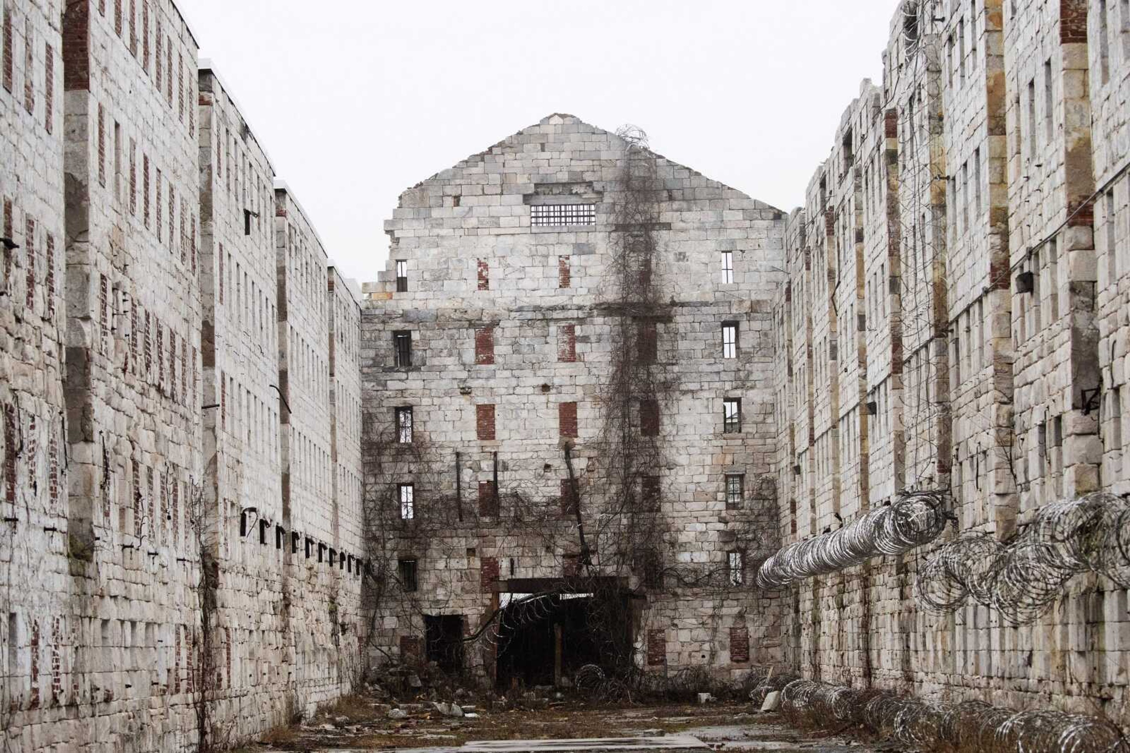 In this Feb. 13, 2020 photo, stone walls are all that remain of a former cell block at Sing Sing Correctional Facility in Ossining, N.Y. The hollowed-out building used to house cells for 1,200 men on six tiers and runs well longer than a football field. It was constructed by inmates who were dropped off at the Hudson River landing in 1825 and ordered to mine limestone from the hillside for what would become their prison. It was used for housing for about a century while the prison grew up around it. (AP Photo/Mark Lennihan)