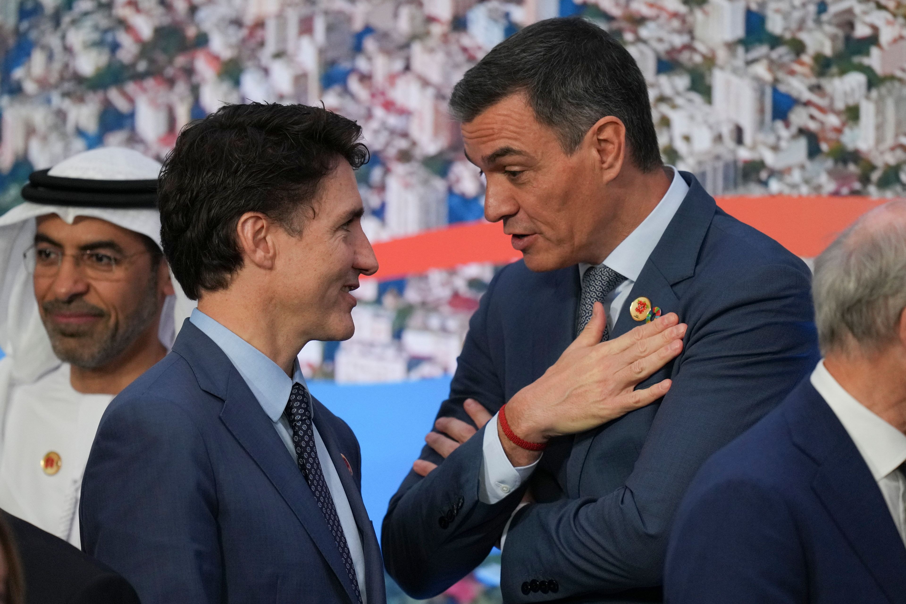 Canada's Prime Minister Justin Trudeau, left, and Spain's Prime Minister Pedro Sanchez talk during the group photo of the G20 Summit, in Rio de Janeiro, Tuesday, Nov. 19, 2024. (AP Photo/Silvia Izquierdo)