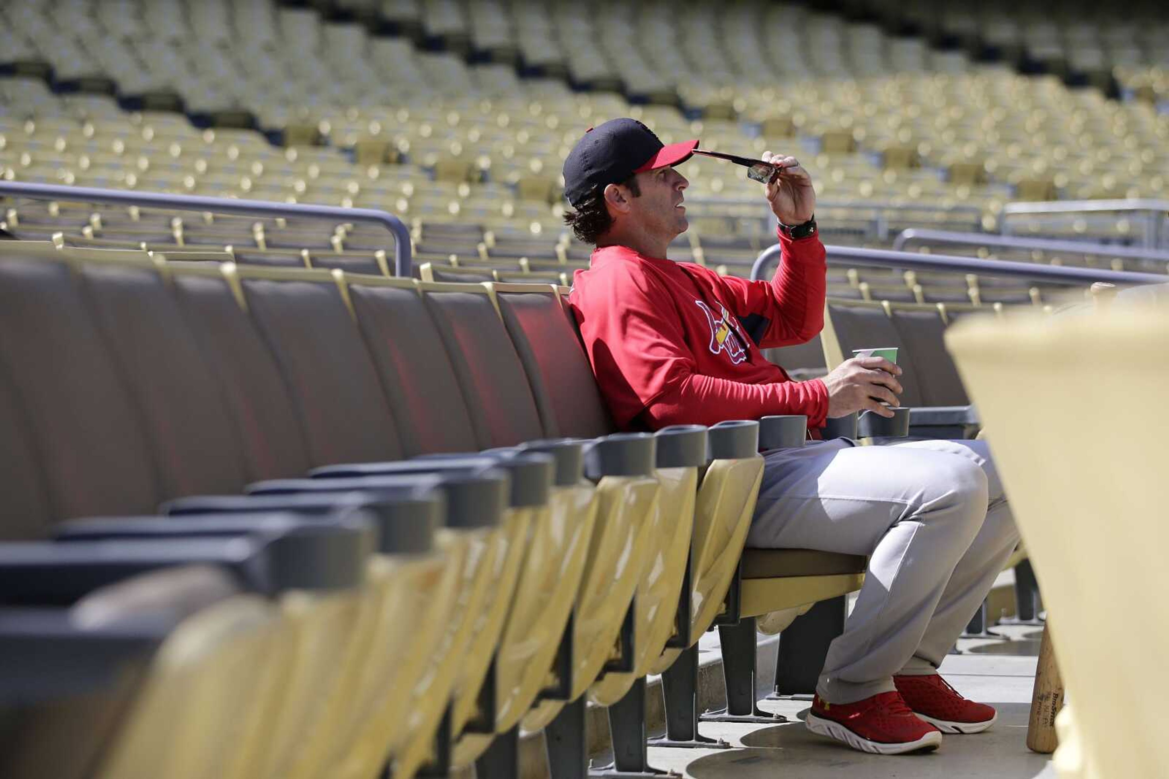 St. Louis Cardinals manager Mike Matheny puts on his sunglasses during practice in preparation for Monday's Game 3 of the National League baseball championship series against the Los Angeles Dodgers, on Sunday, Oct. 13, 2013, in Los Angeles. (AP Photo/Jae C. Hong)