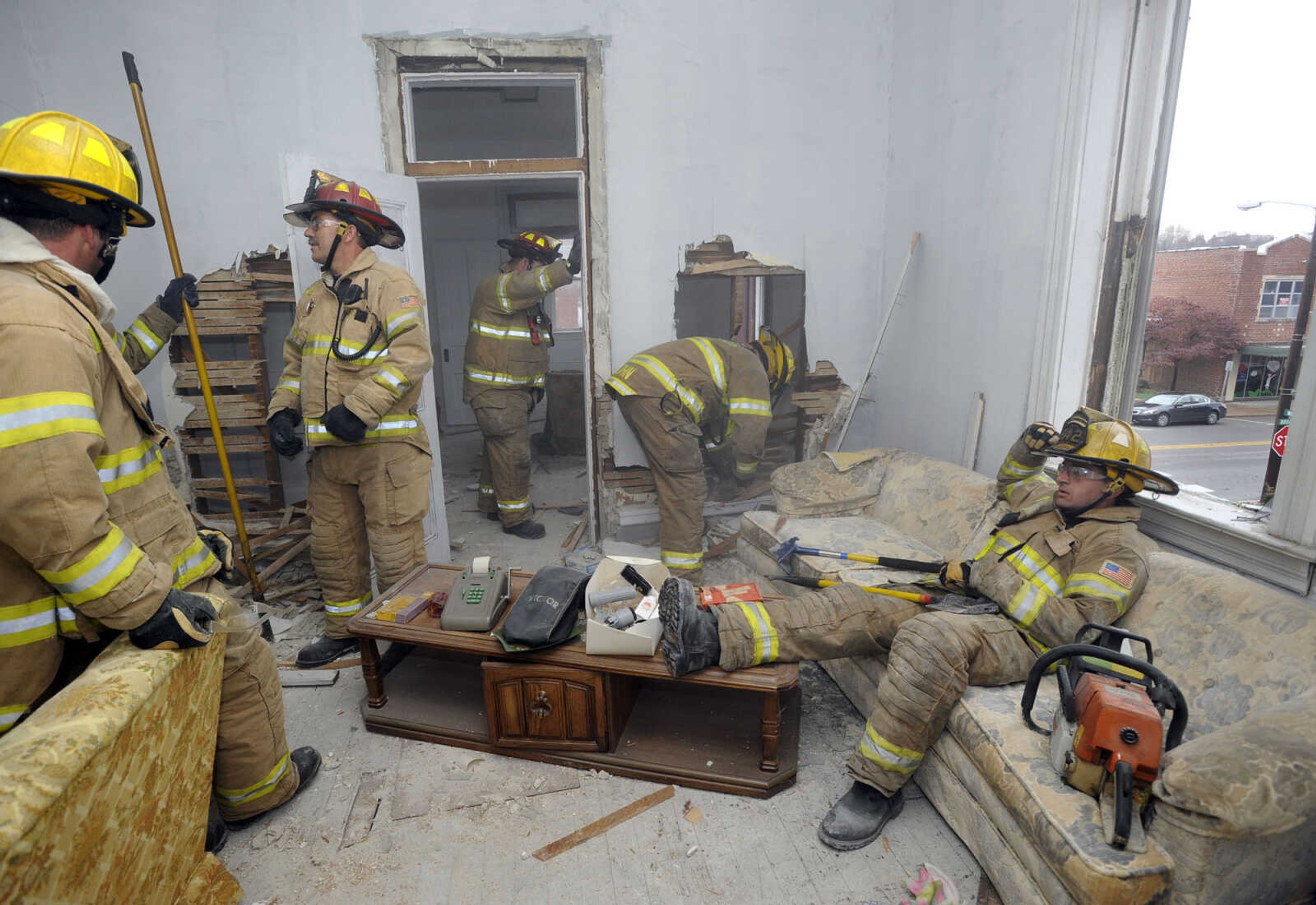 The firefighters are using the old building for various training scenarios before it is razed.