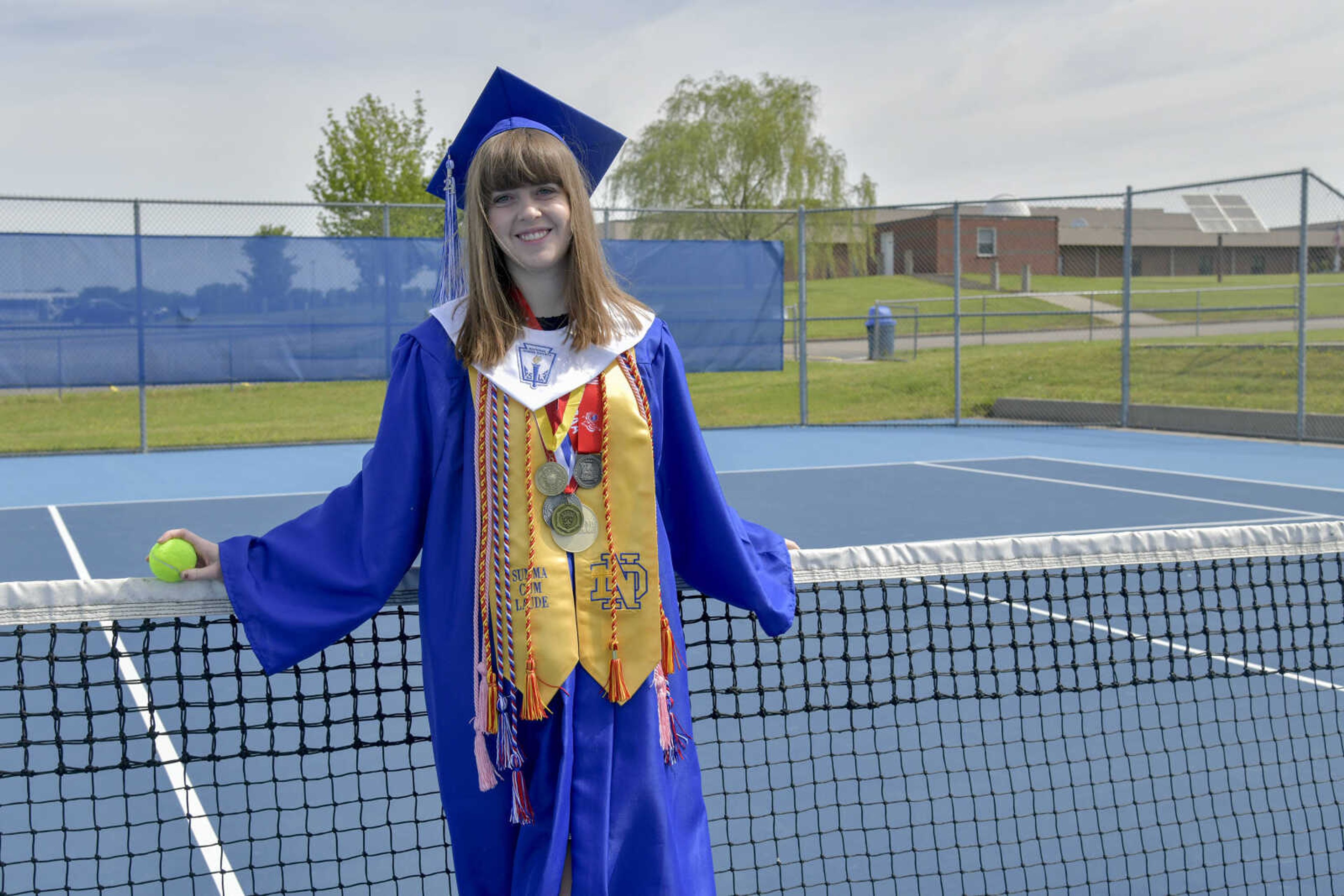 Notre Dame's valedictorian Claire Southard poses for a photo at the school's tennis court in May. She played tennis for the school all four years.