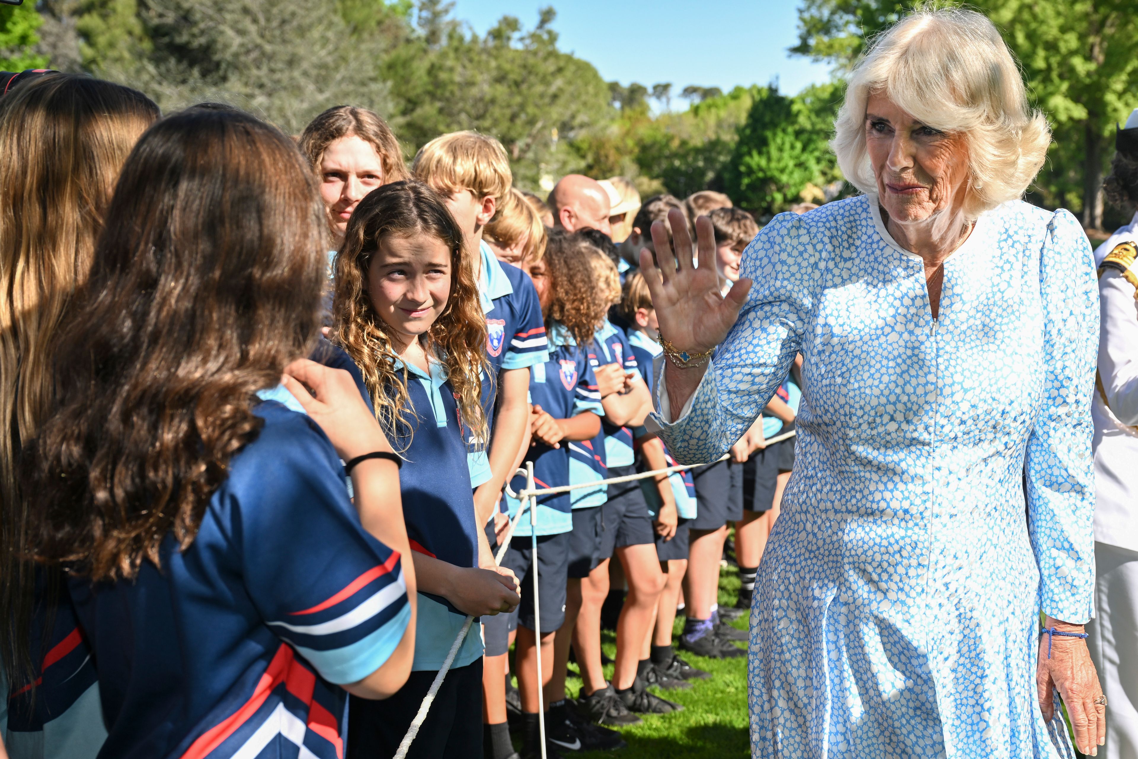 Britain's Queen Camilla speaks to schoolchildren after planting a tree at Government House in Canberra, Australia, Monday, Oct. 21, 2024. (Saeed Khan/Pool Photo via AP)