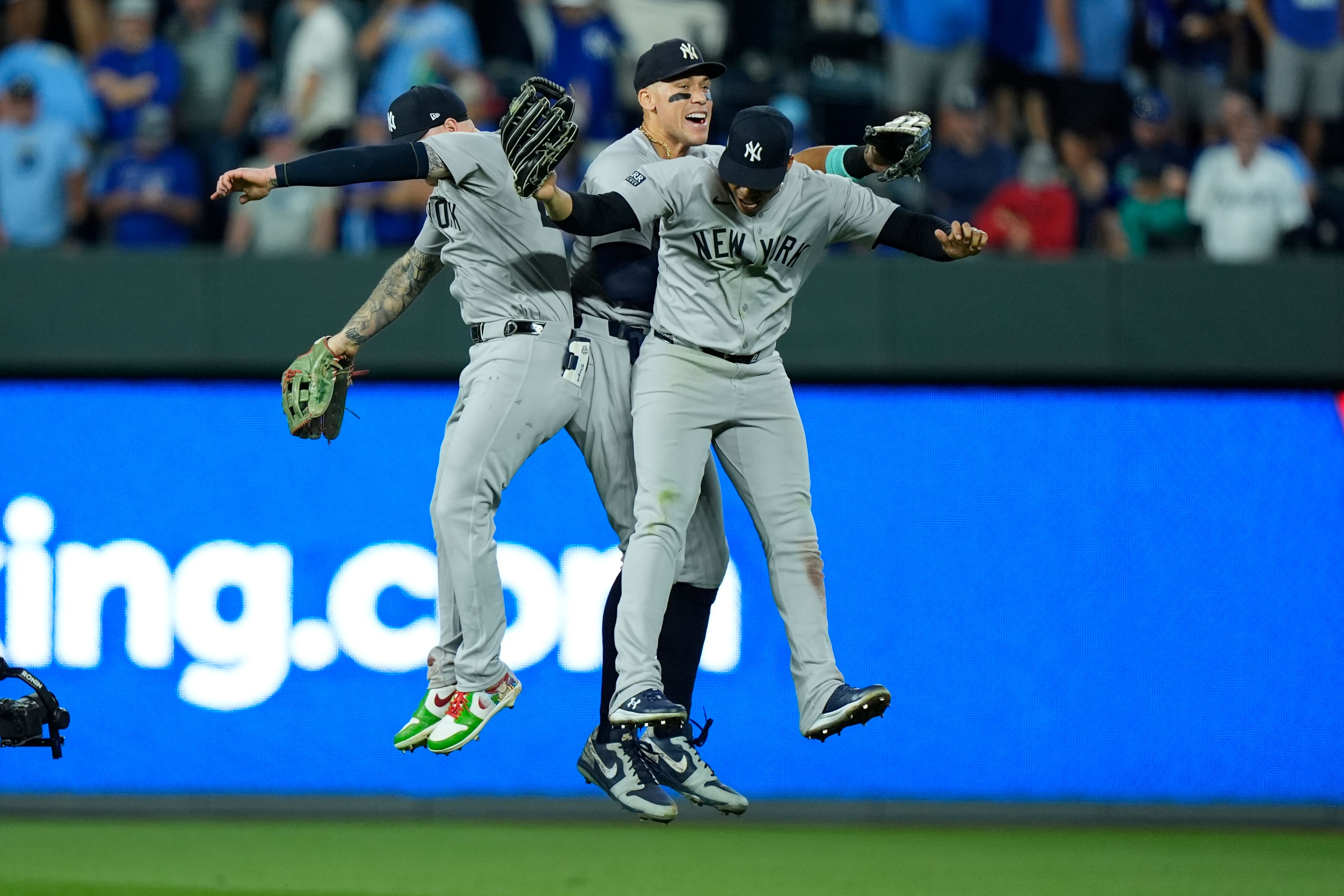 New York Yankees Alex Verdugo, left, Aaron Judge and Juan Soto, right, celebrate a 3-2 victory over the Kansas City Royals in Game 3 of an American League Division baseball playoff series Wednesday, Oct. 9, 2024, in Kansas City, Mo. (AP Photo/Charlie Riedel)