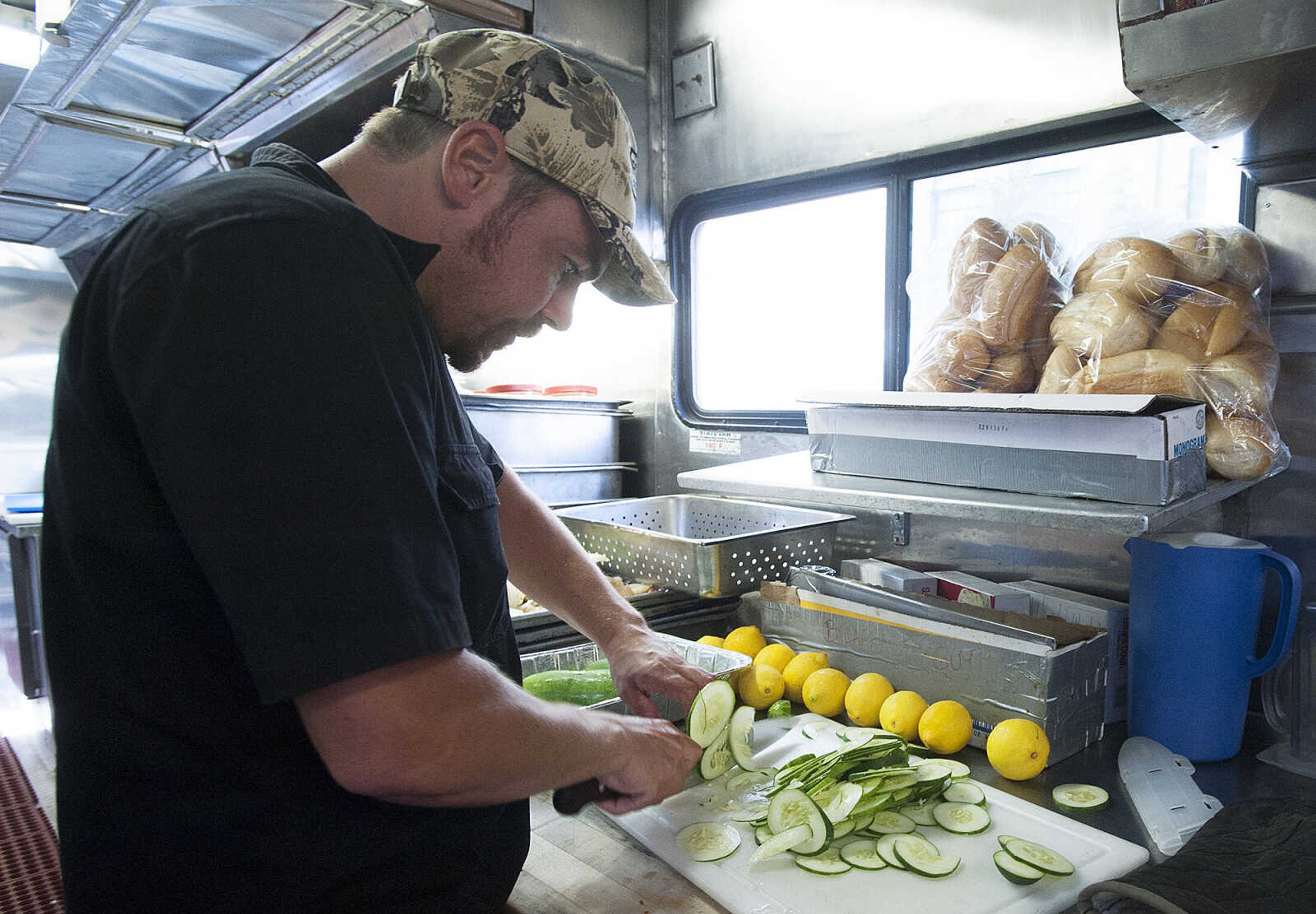 ADAM VOGLER ~ avogler@semissourian.com
Paul Musgrave, of Mission Viejo, Calif., slices cucumbers for a pitcher of cucumber water Thursday, Oct. 3. For Stars Catering, which is based in Carlsbad N. M., is serving meals to up to 120 members of the cast and crew of the 20th Century Fox feature film "Gone Girl," each day.