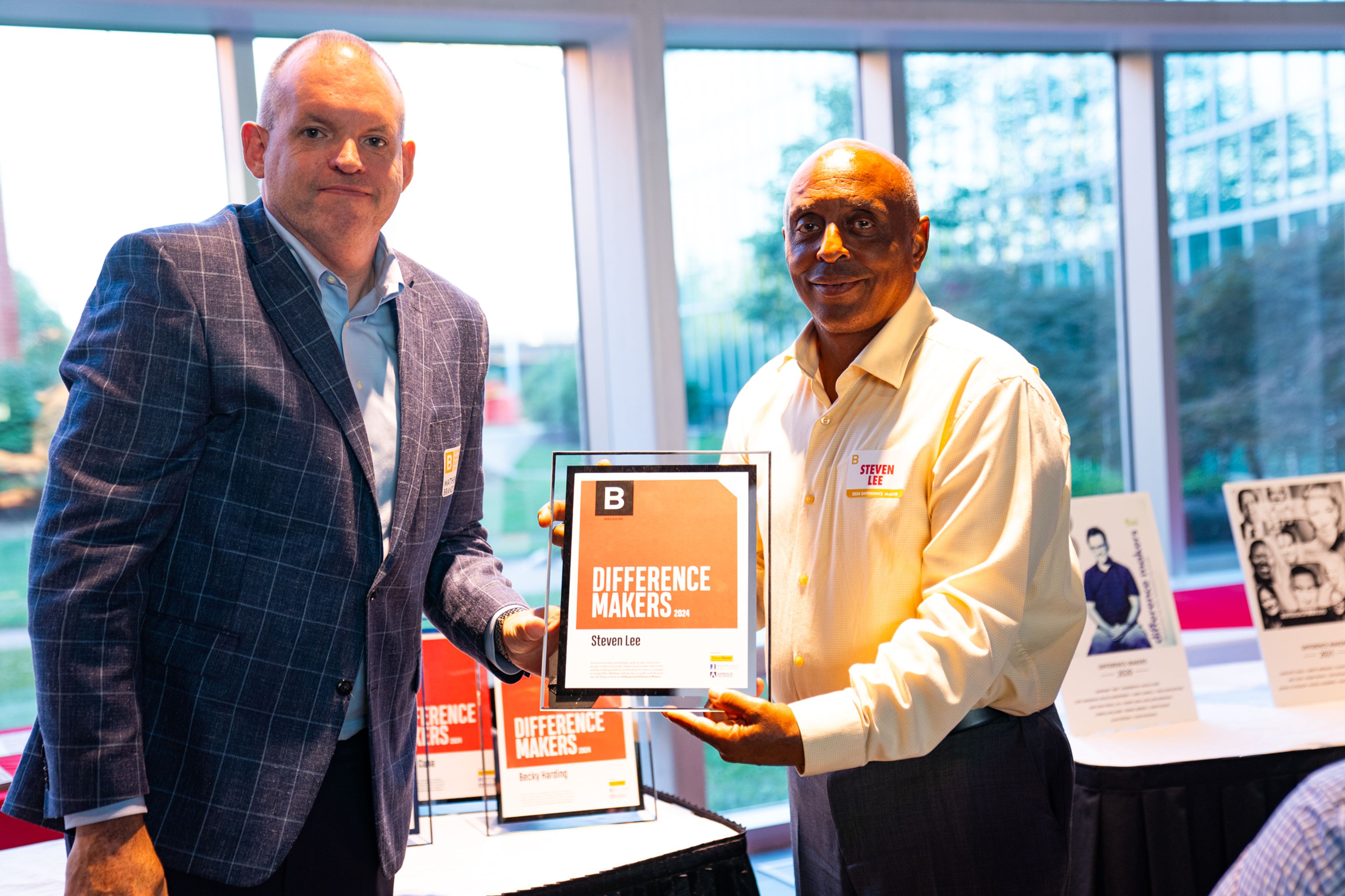 Steven Lee receives a plaque from Saint Francis Healthcare System’s Matthew Brandt recognizing him as a 2024 Difference Maker at their reception at Southeast Missouri State University’s River Campus. The Difference Maker’s reception was presented by B Magazine on Thursday, Sept. 6.